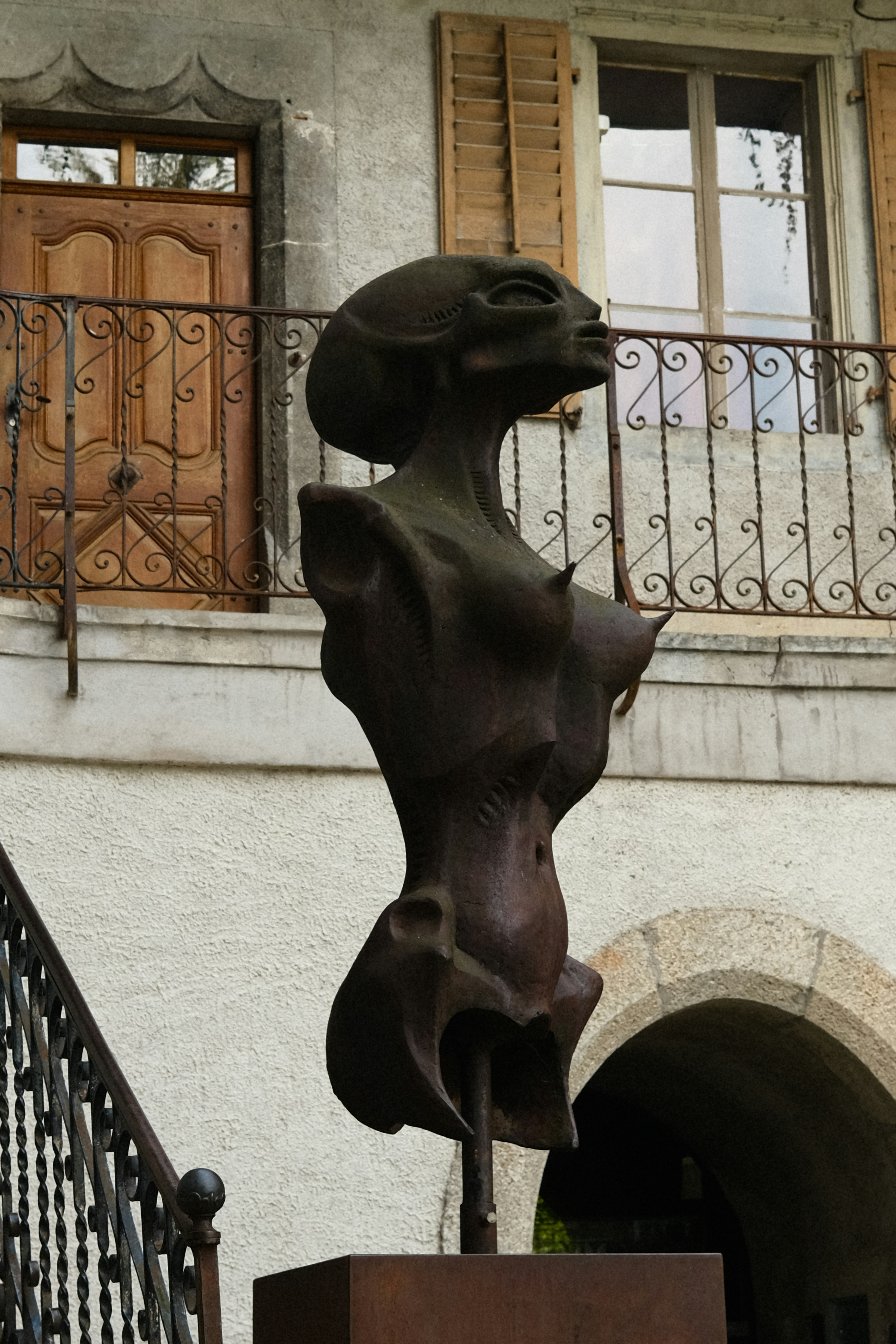 A statue of a woman on a pedestal in front of a building