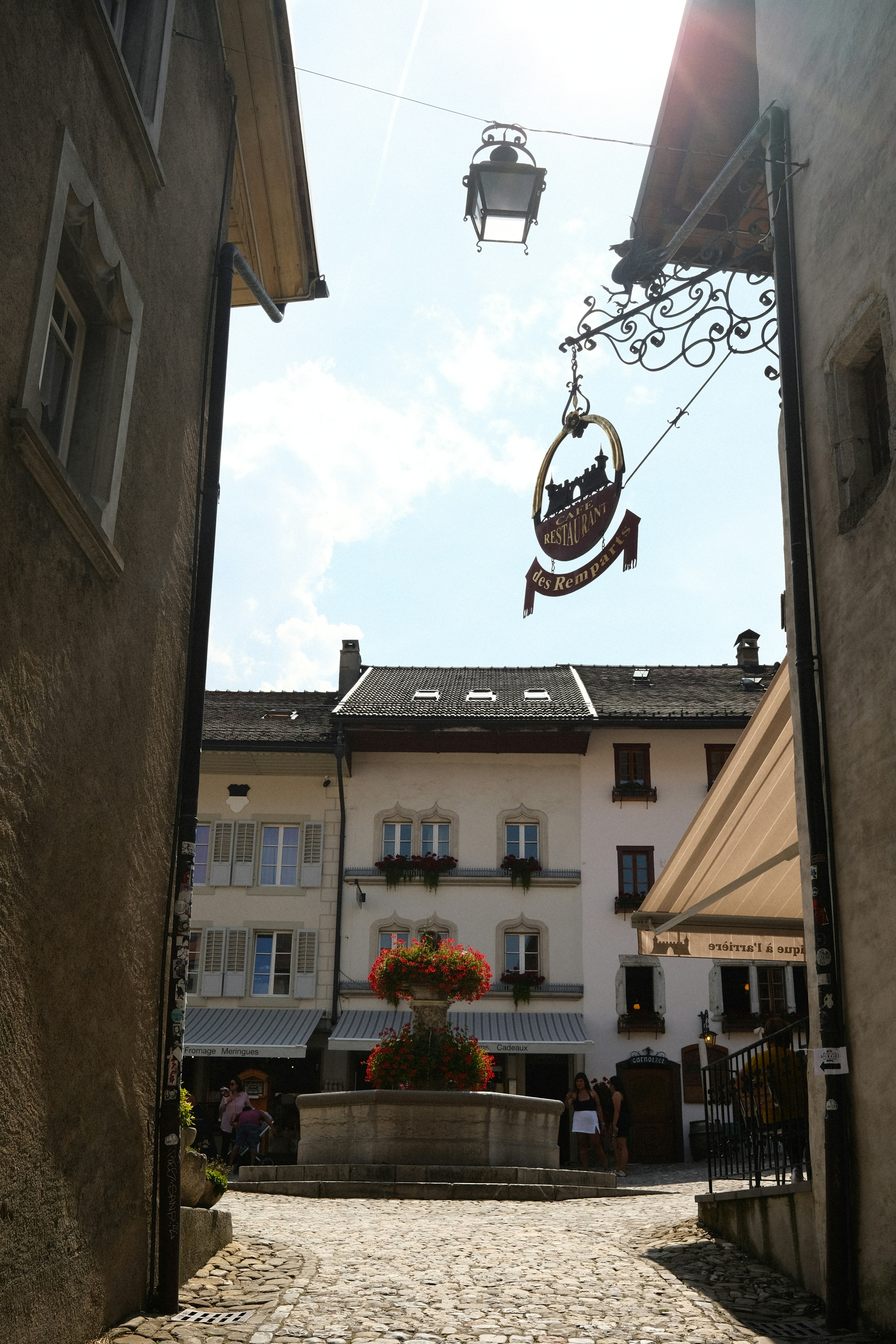 A cobblestone street with a building in the background