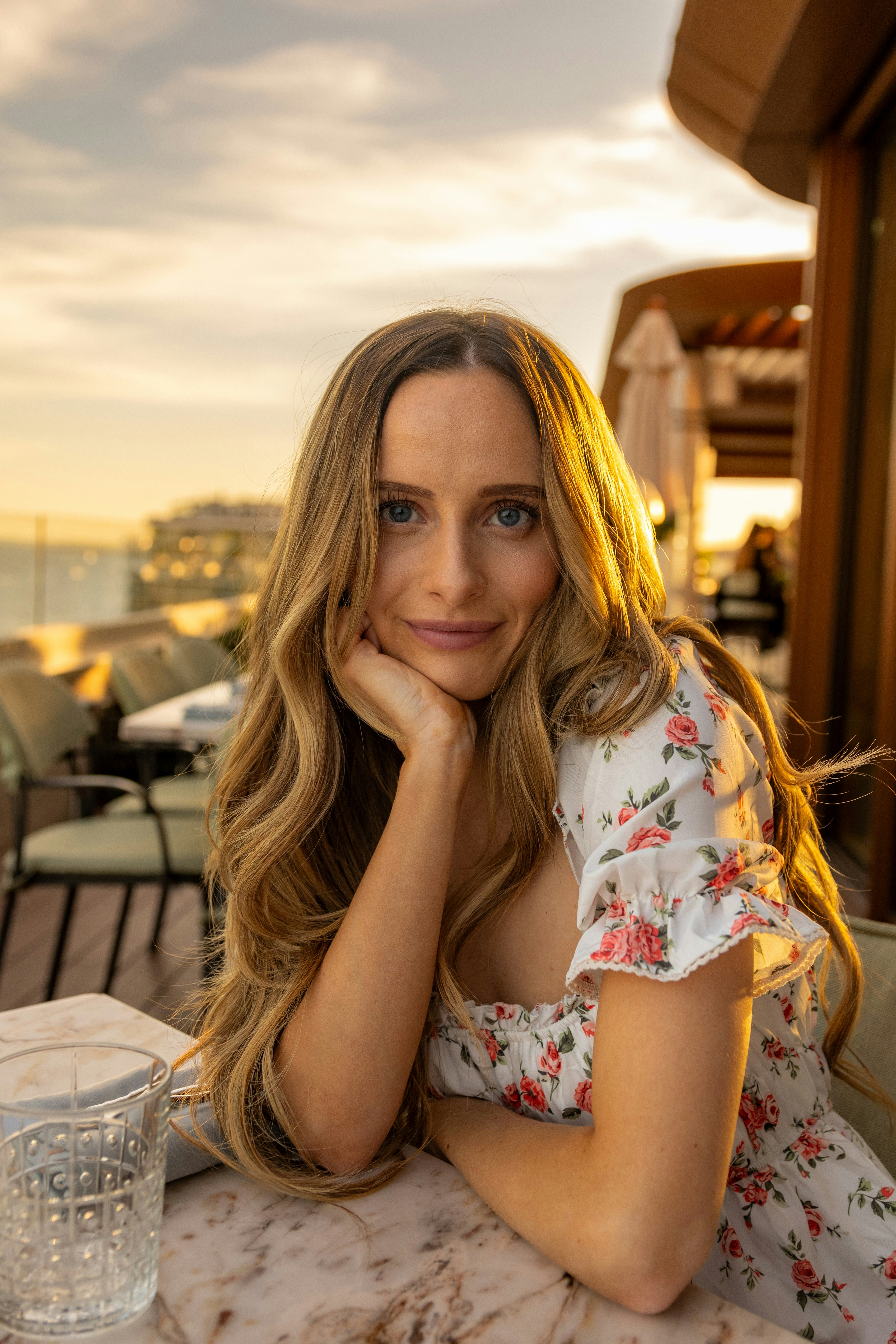 A woman sitting at a table with a glass of water