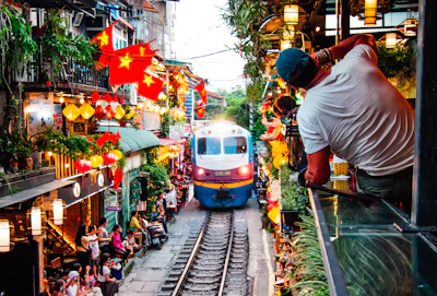 A train traveling down train tracks next to a crowd of people