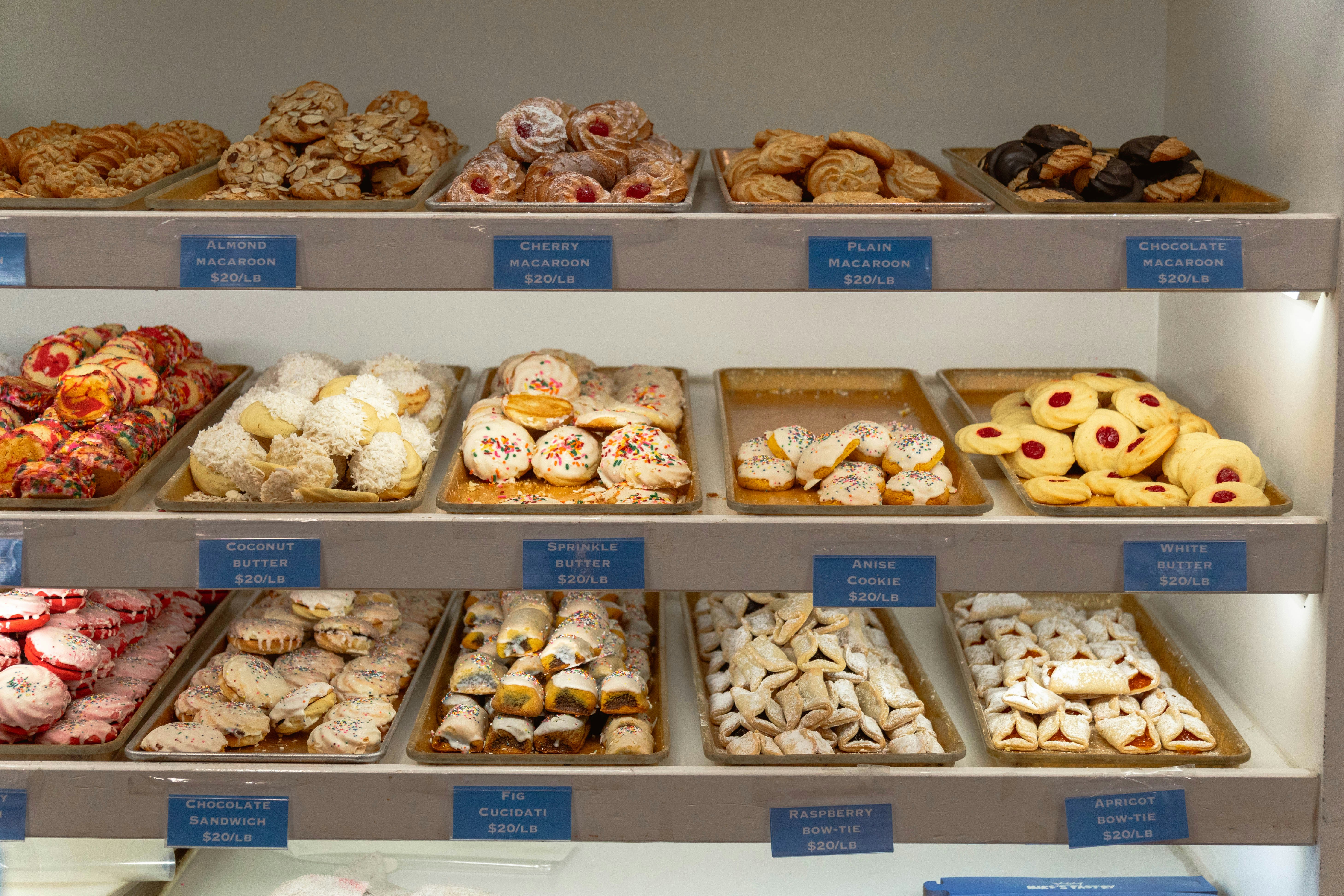 A display case filled with lots of different types of doughnuts