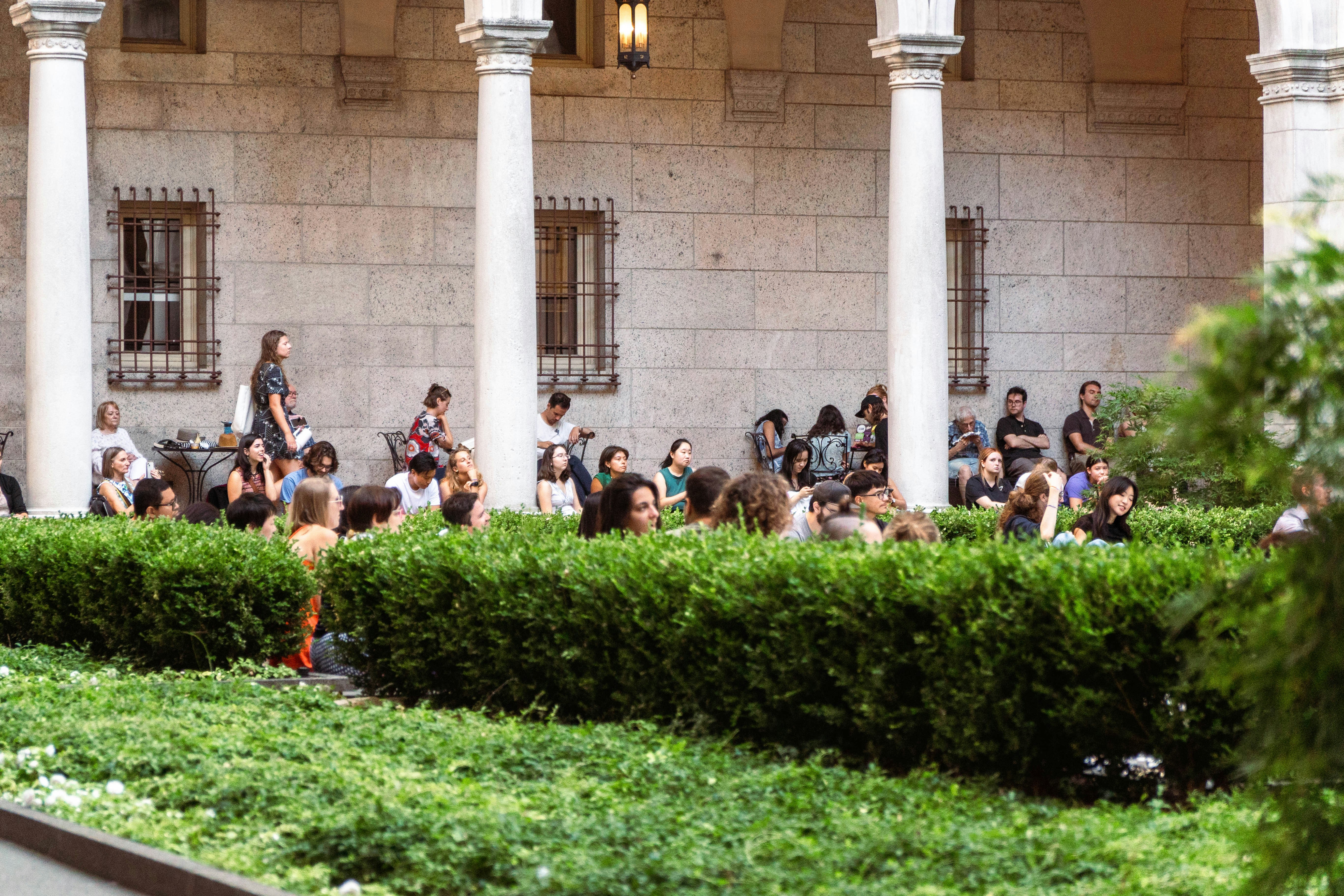 A group of people sitting in front of a building