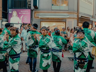 A group of people dressed in green and white