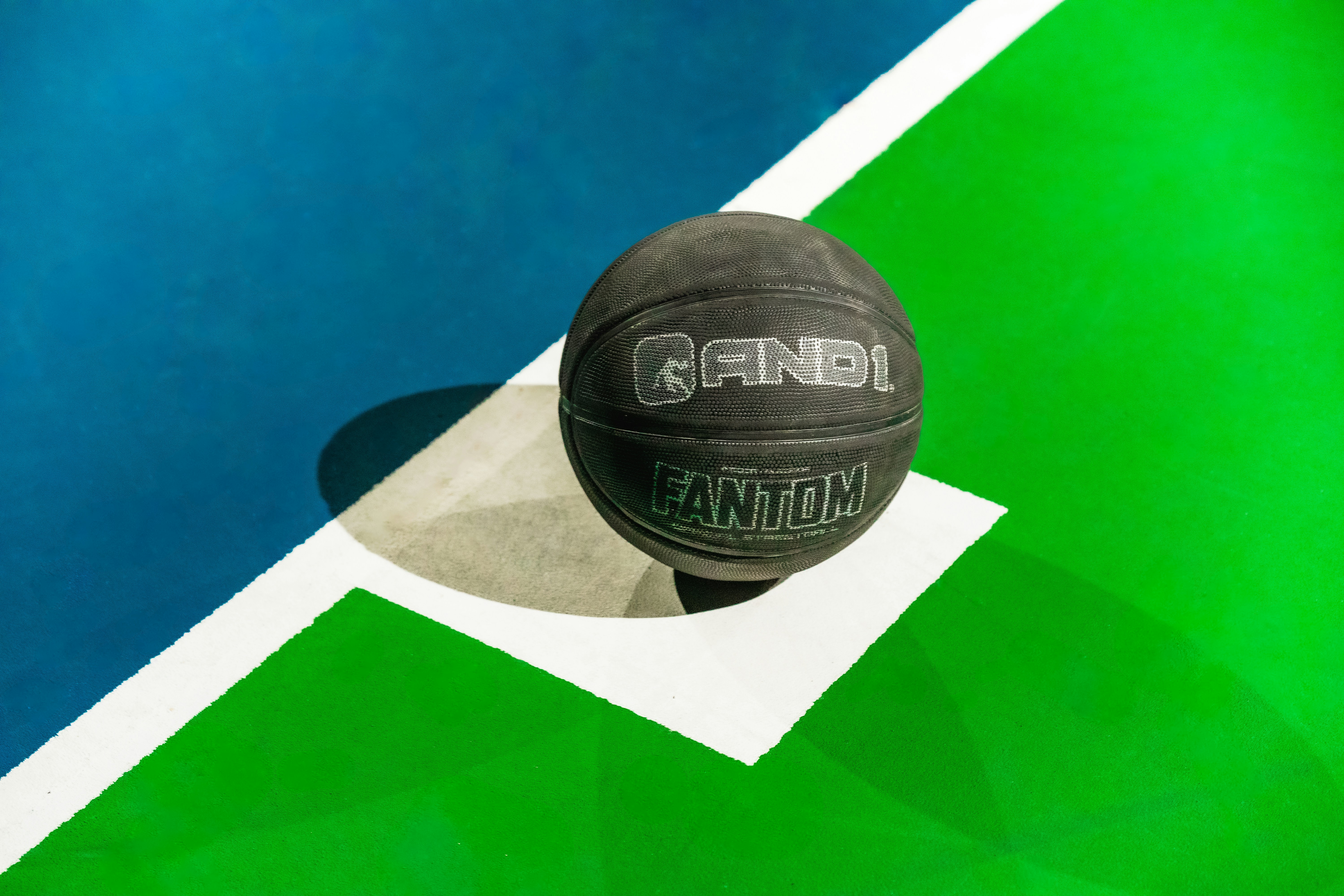 A basketball sitting on top of a basketball court