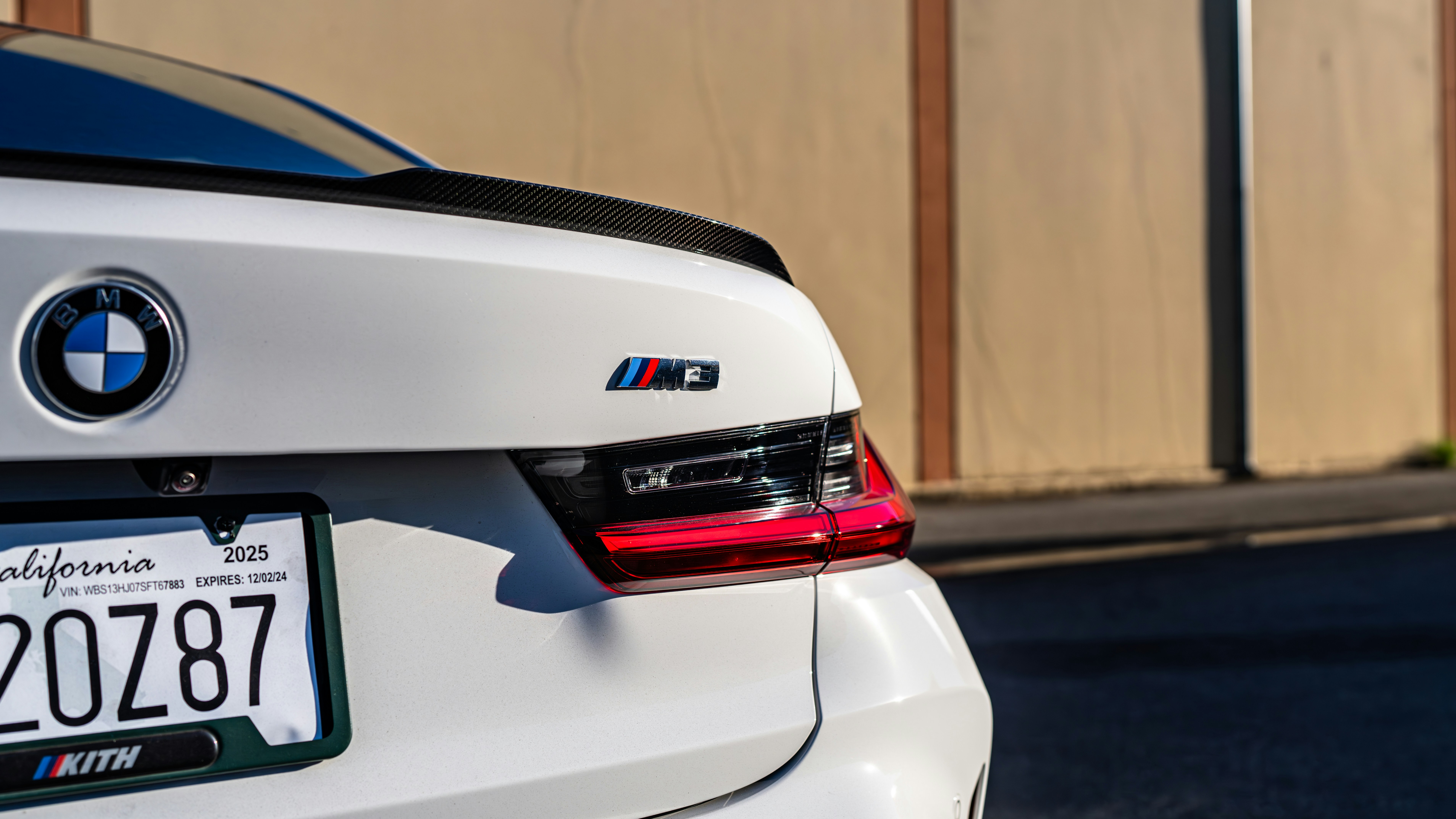 A white BMW car parked on the side of the road