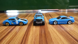 A group of toy cars sitting on top of a wooden floor
