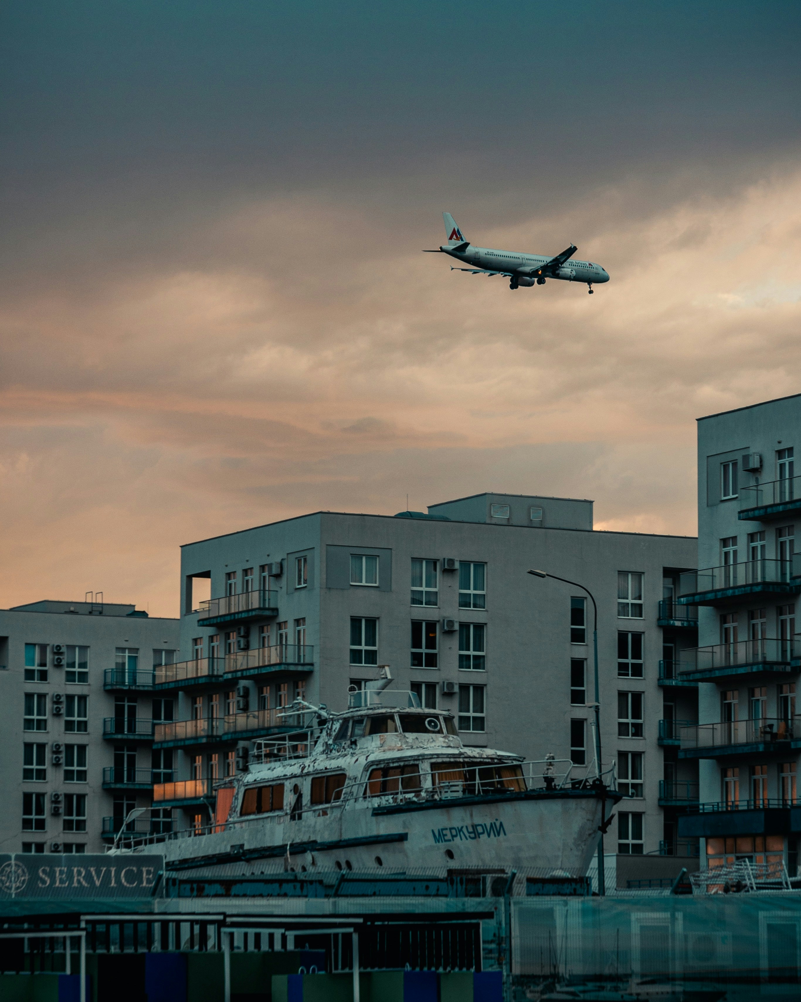 An airplane is flying over a boat in the water