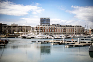 A harbor filled with lots of boats next to tall buildings
