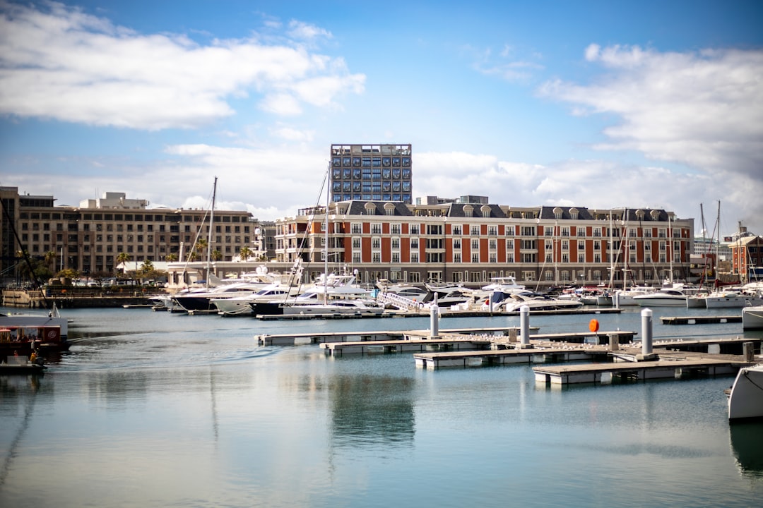 A harbor filled with lots of boats next to tall buildings,