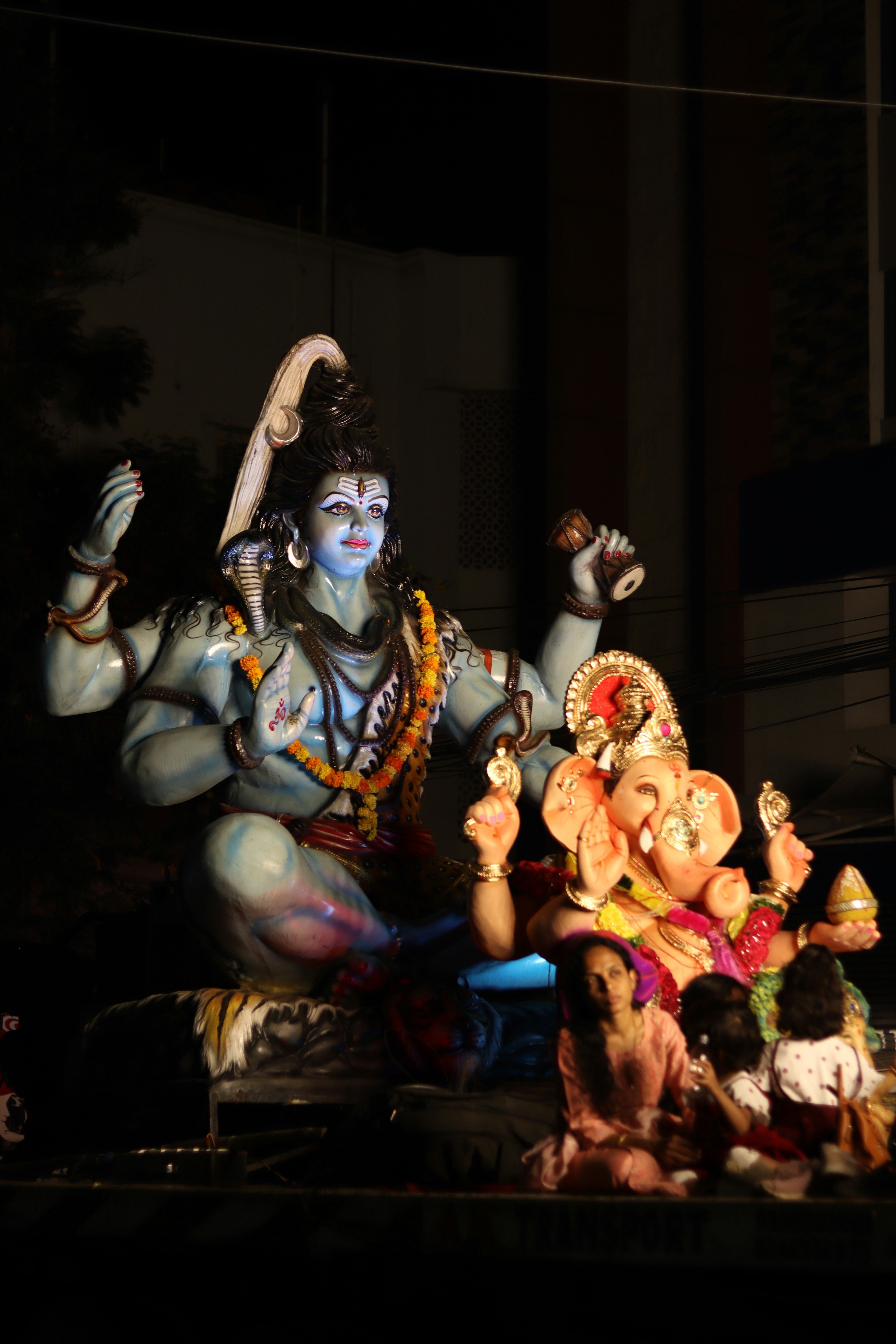 A statue of a hindu god surrounded by other statues