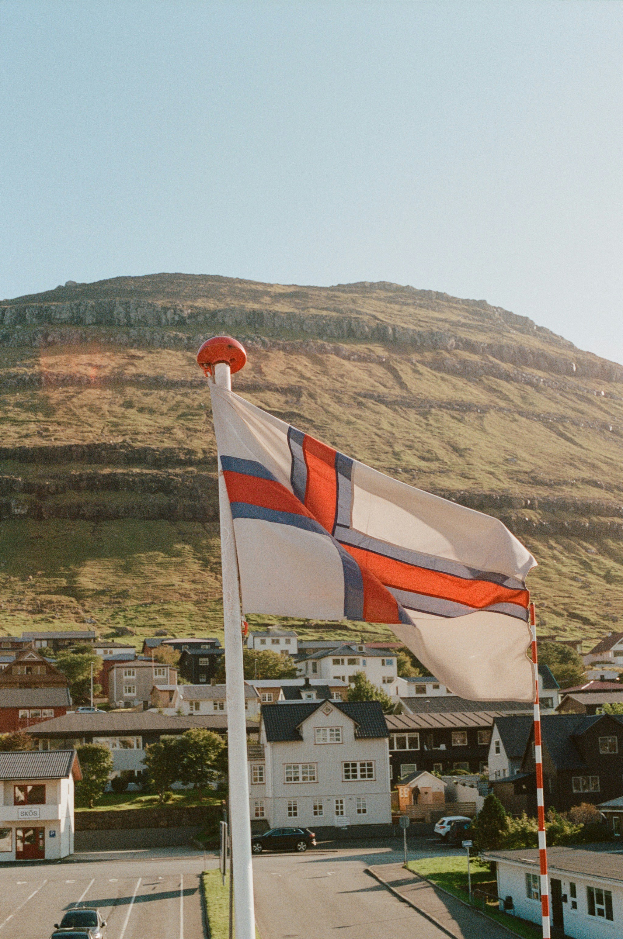 A flag flying in the wind on a city street