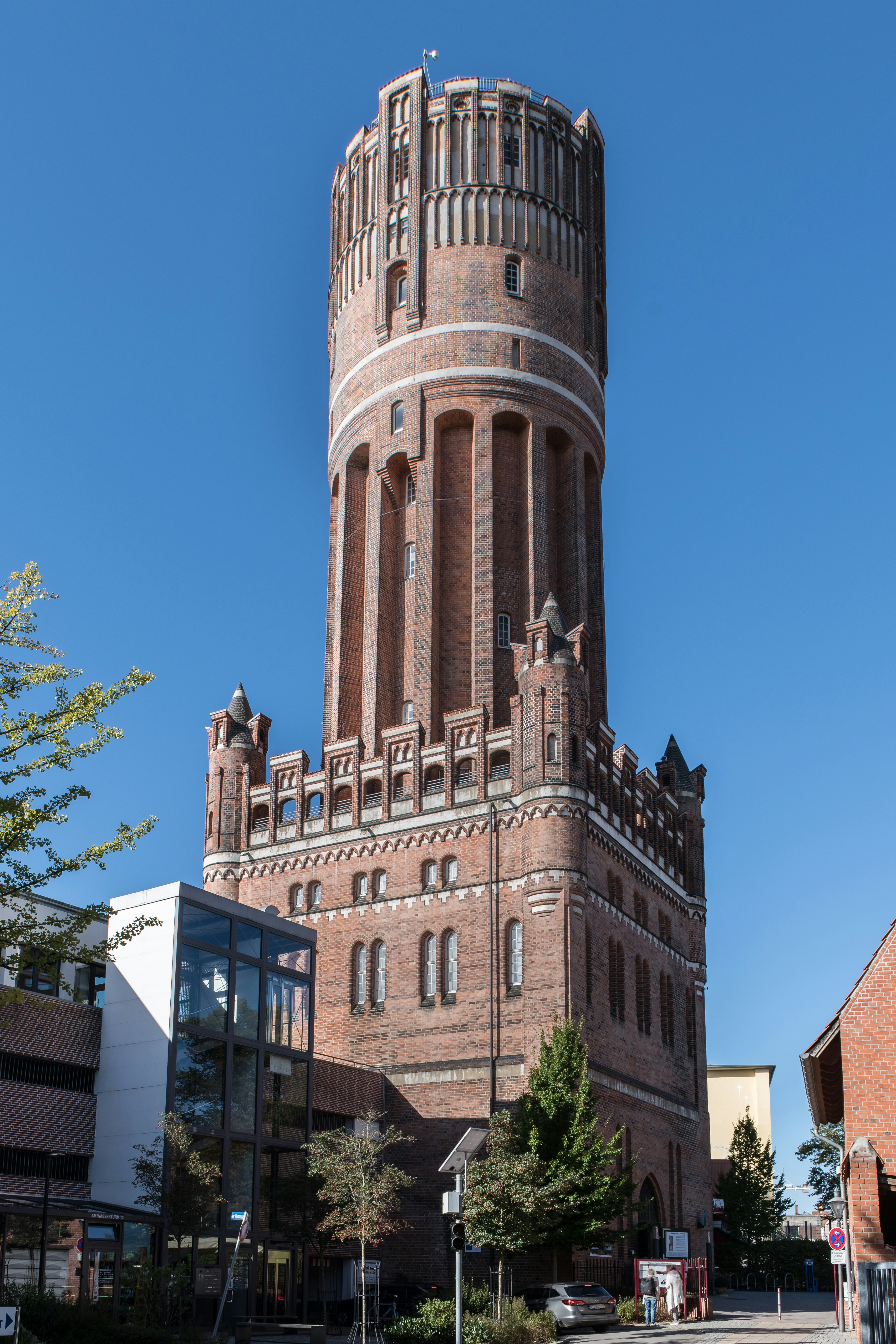 A tall brick tower with a clock on the top of it