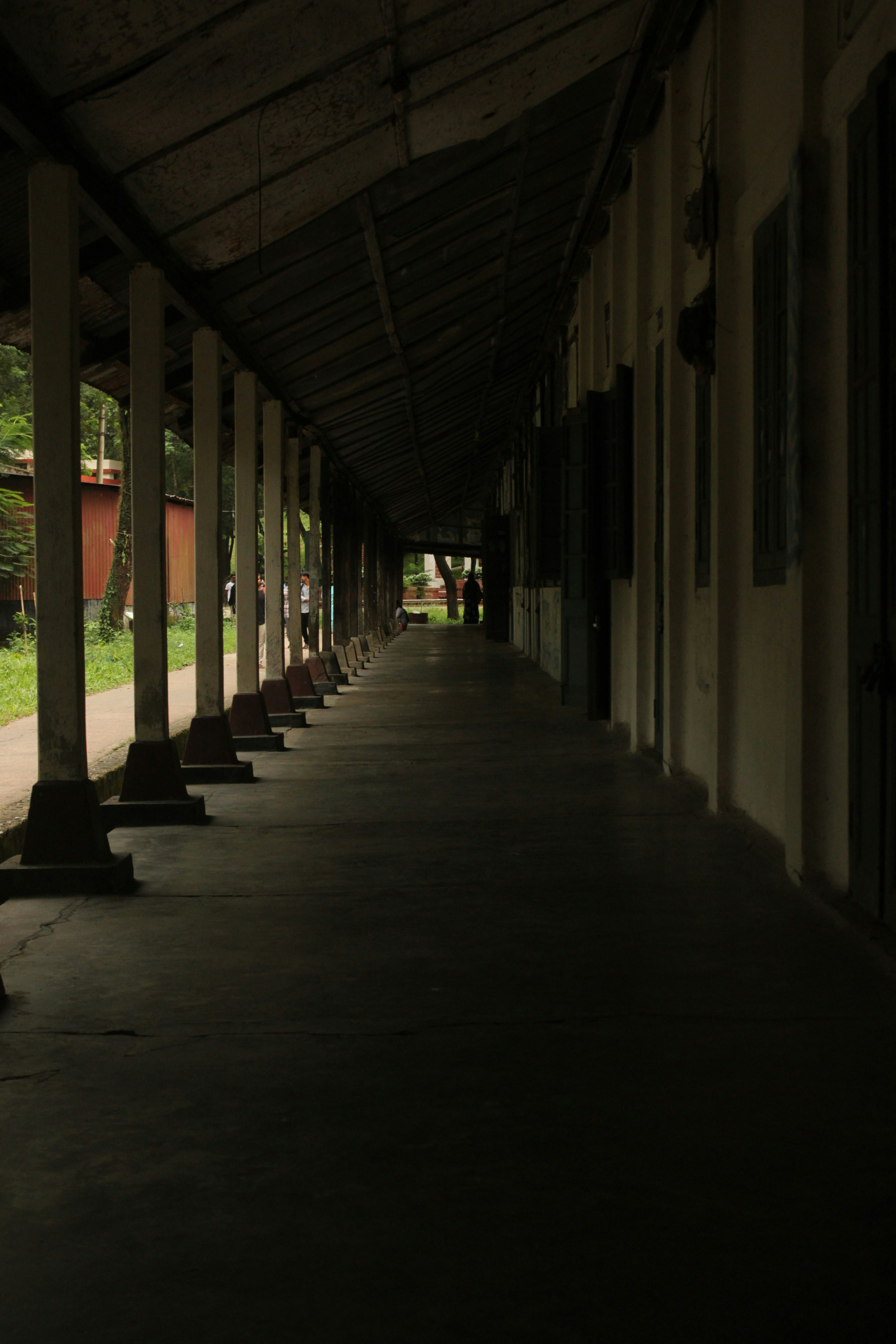 A row of benches sitting next to each other under a roof