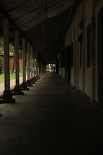A row of benches sitting next to each other under a roof
