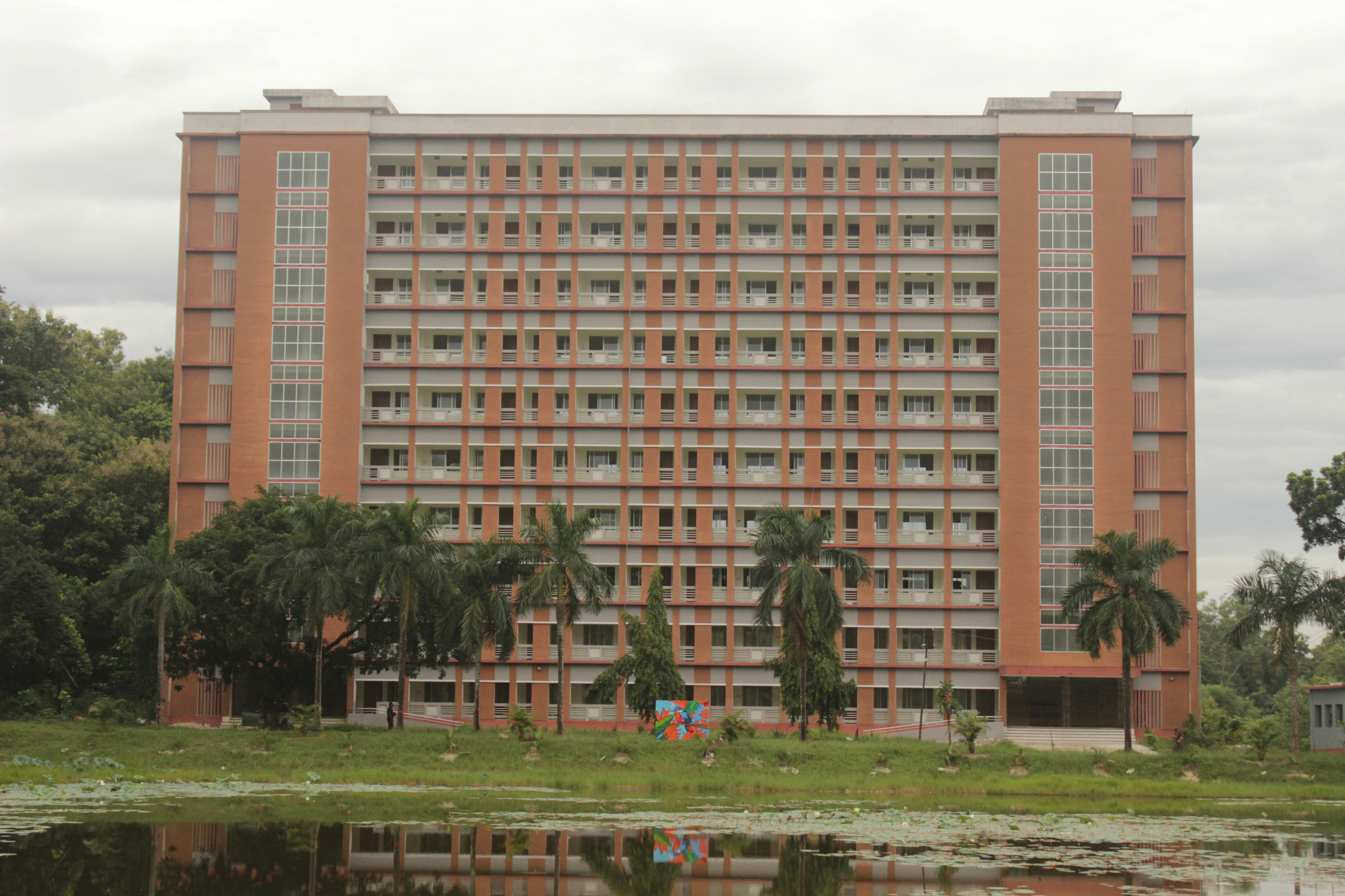 A large building with a lake in front of it