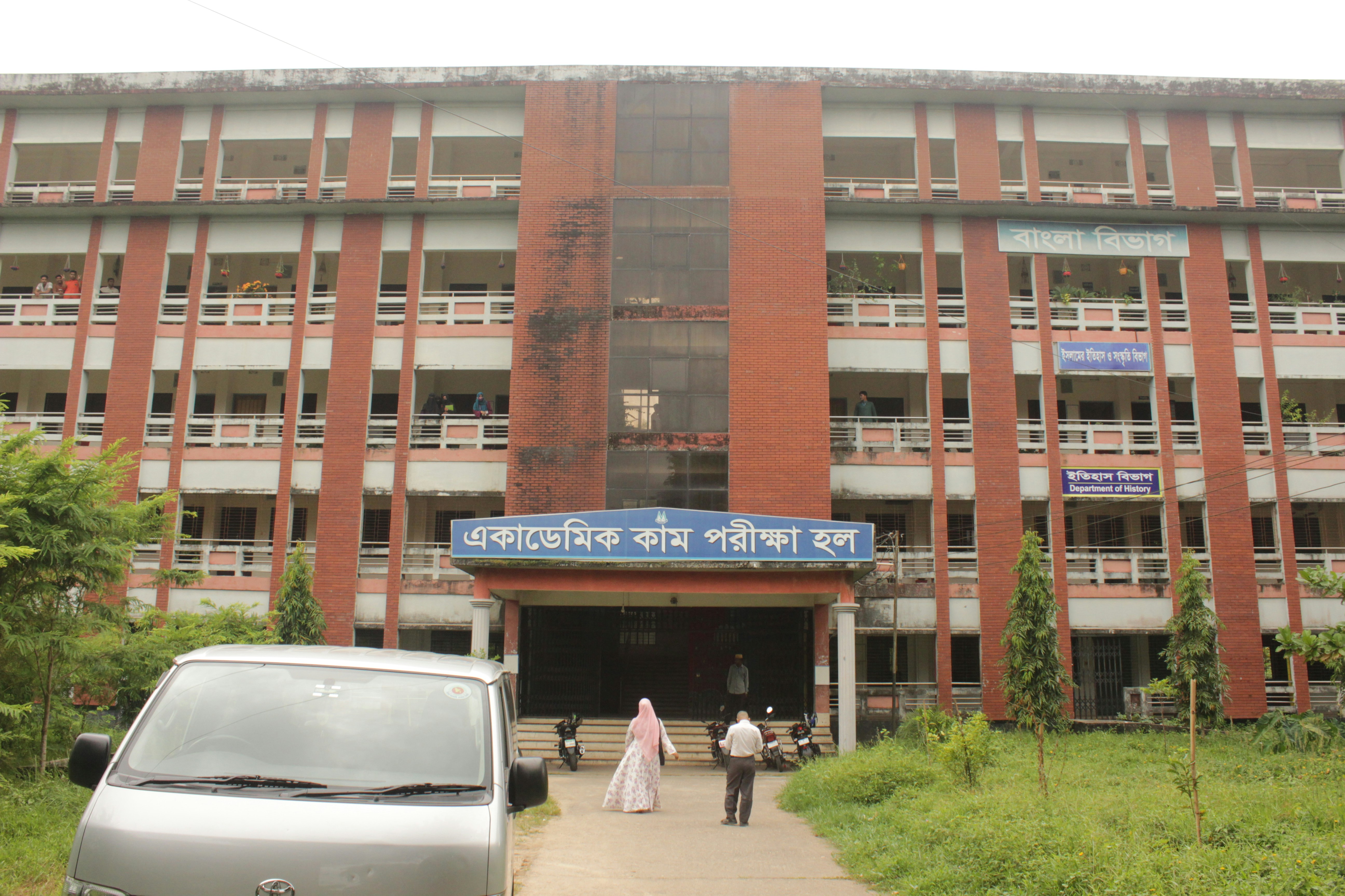 A car parked in front of a tall building