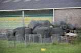 A pile of tires sitting in front of a building