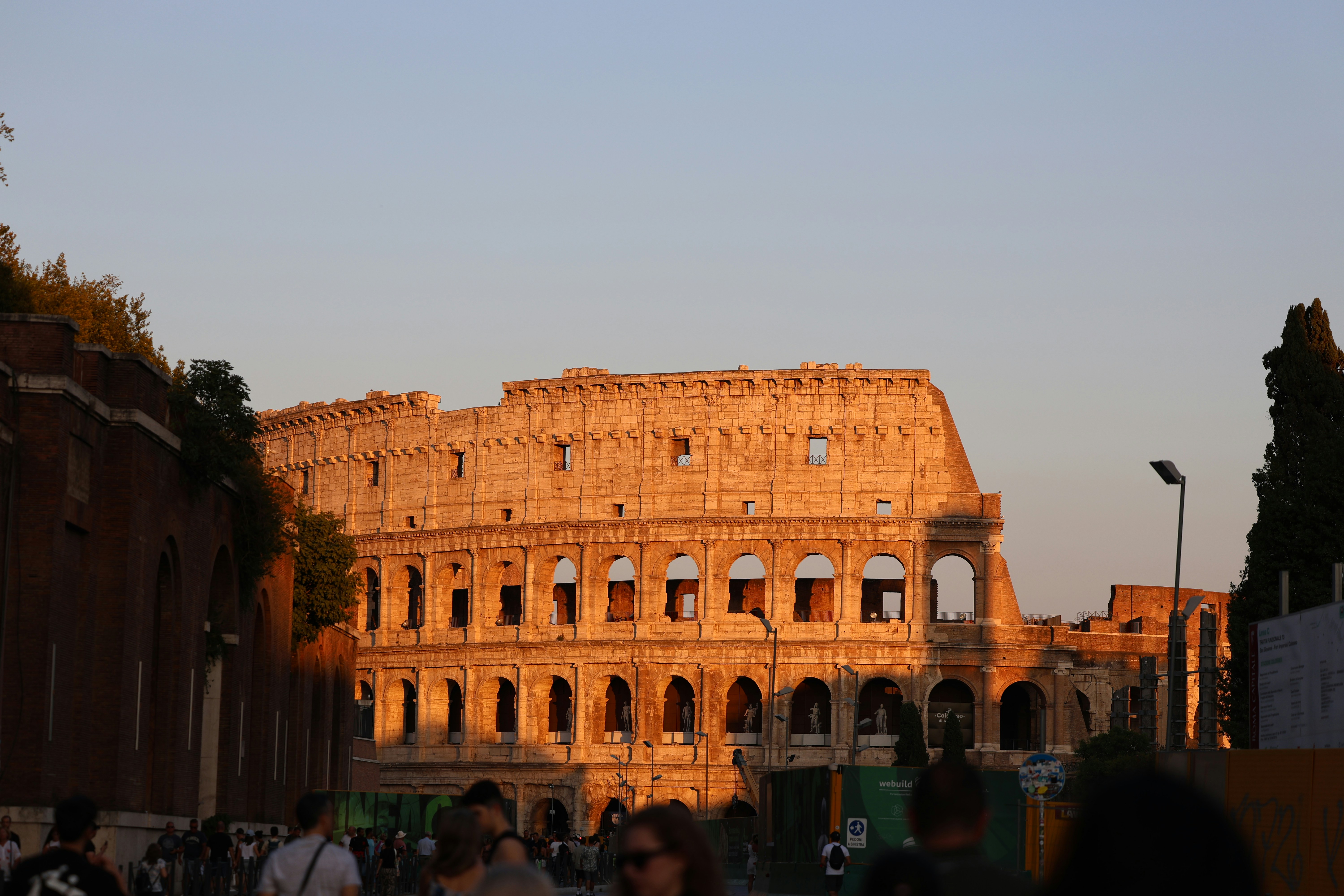 A crowd of people walking around a large building