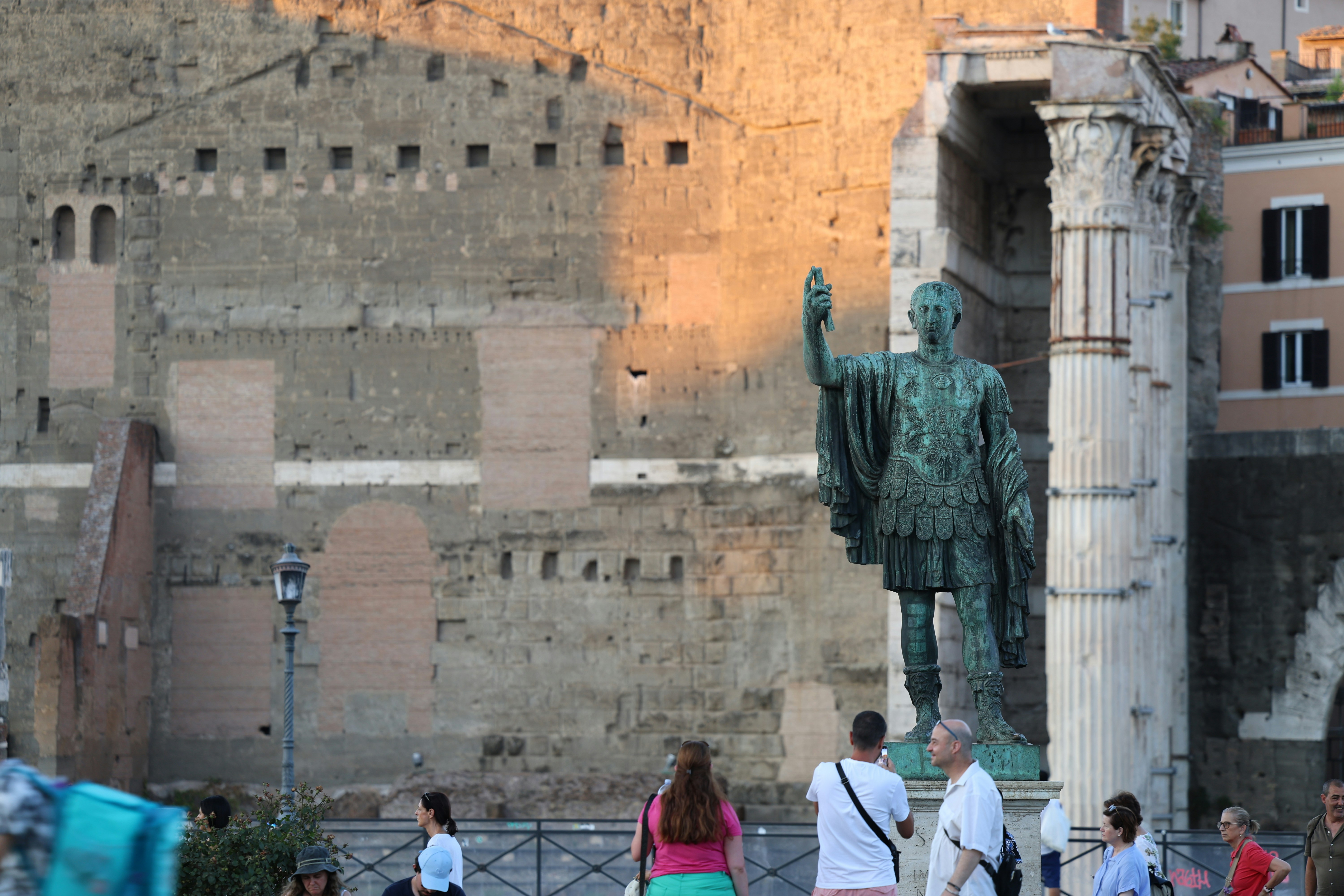 A group of people standing around a statue