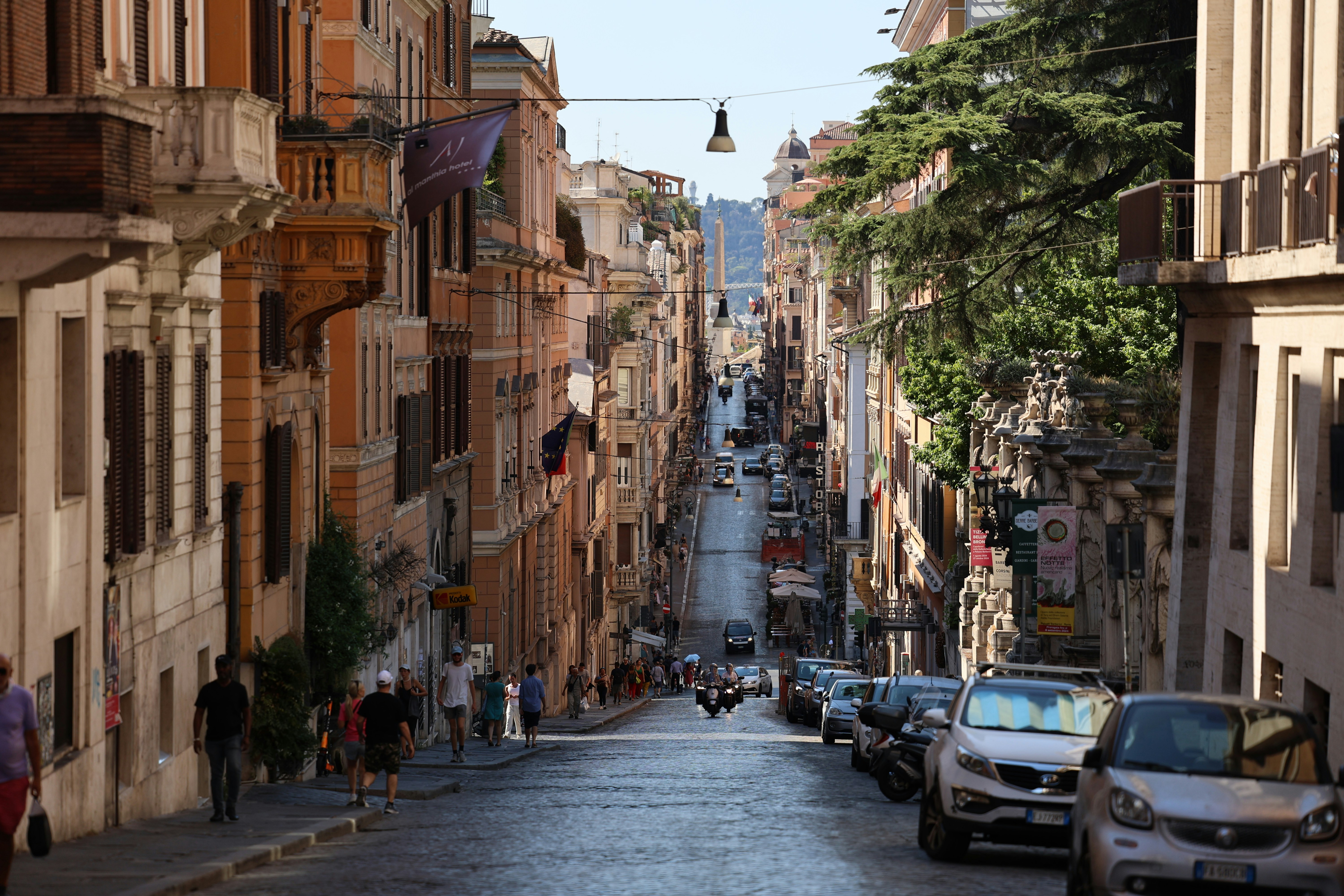 A city street with cars parked on both sides of it