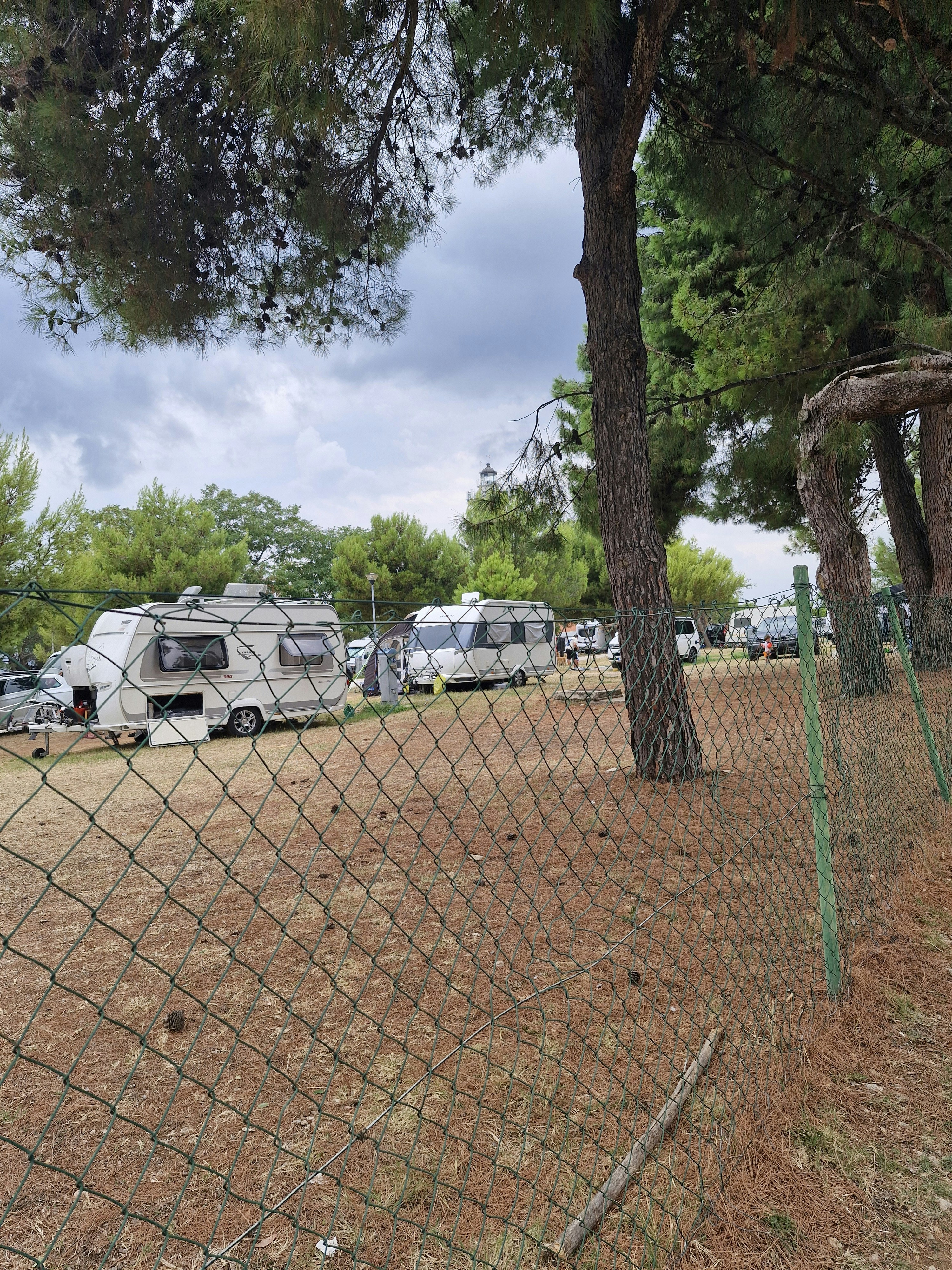 A fenced in area with a lot of parked cars
