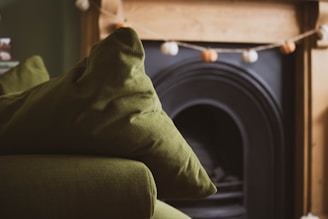 A living room with a couch and a fire place