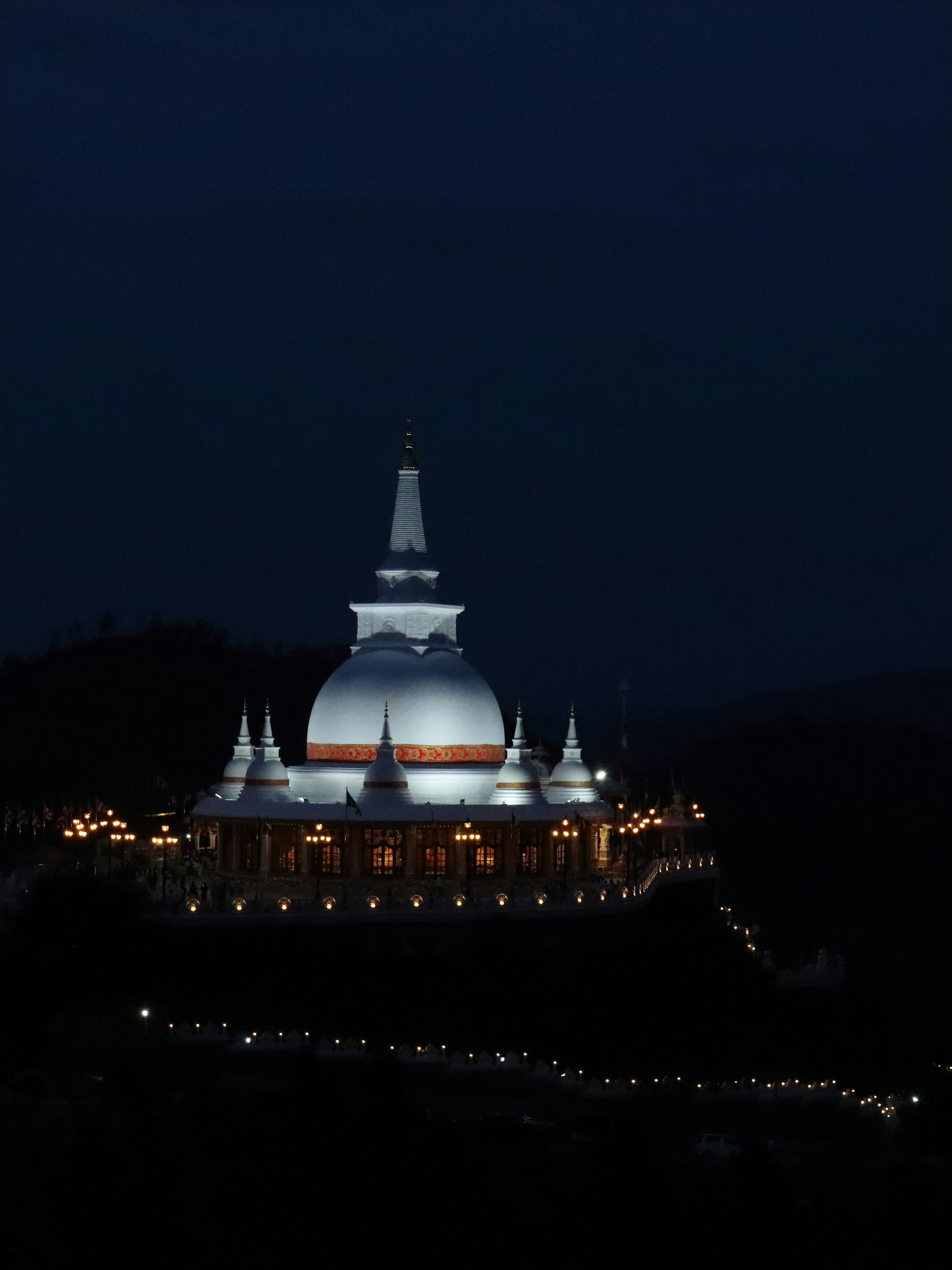 A building lit up at night with a sky background