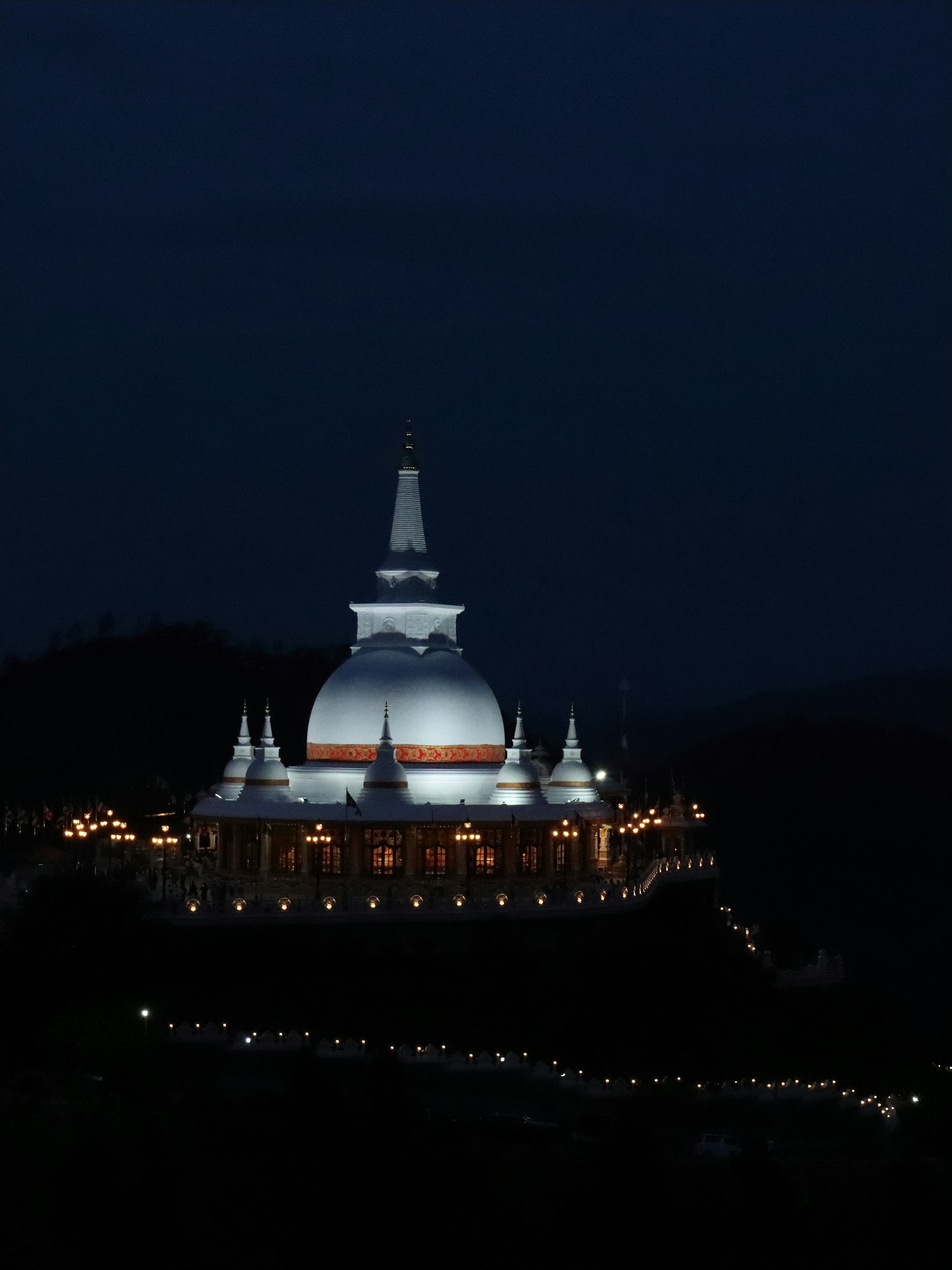 A building lit up at night with a sky background