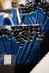 A close up of a bunch of blue and black pens