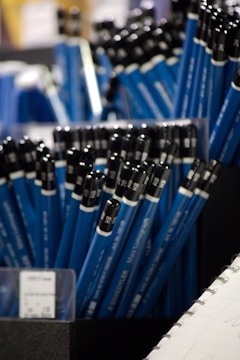 A close up of a bunch of blue and black pens