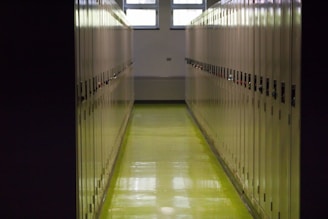 A long hallway in a building with yellow floors