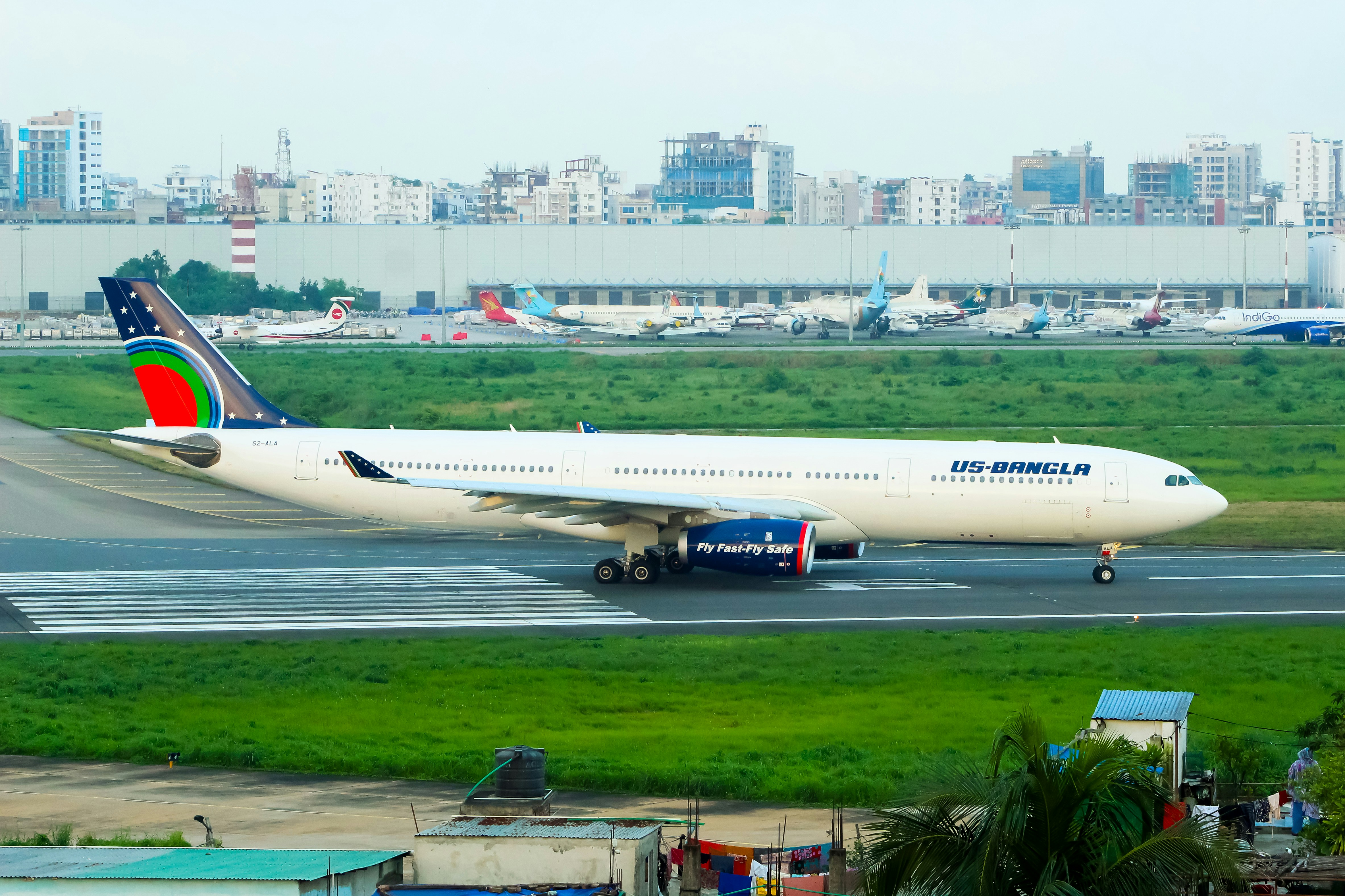 A large jetliner sitting on top of an airport runway, Us-Bangla Airlines Airbus A330-300