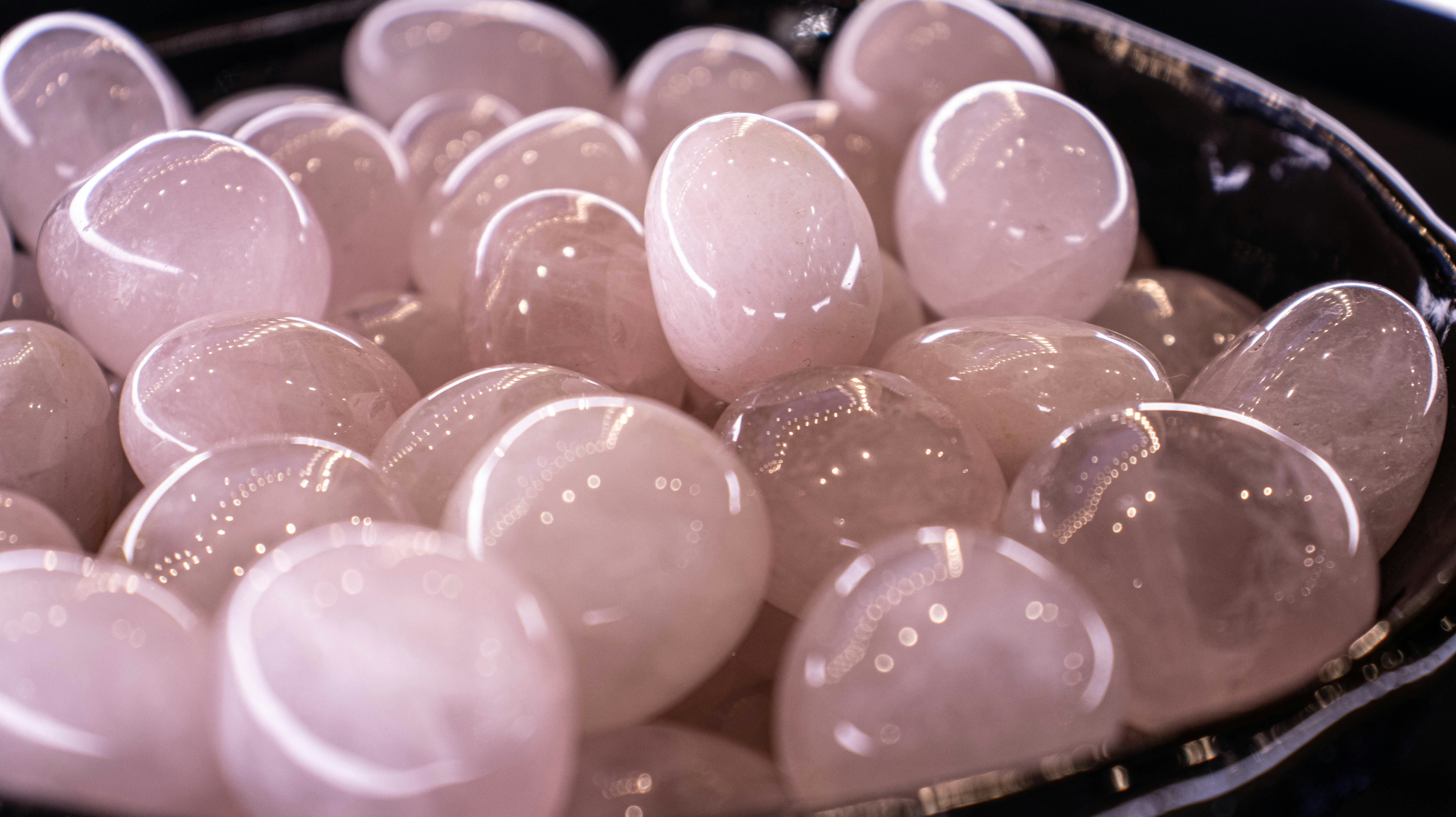 A bowl filled with lots of white hearts on top of a table