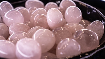 A bowl filled with lots of white hearts on top of a table