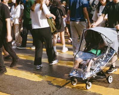 A group of people walking across a street