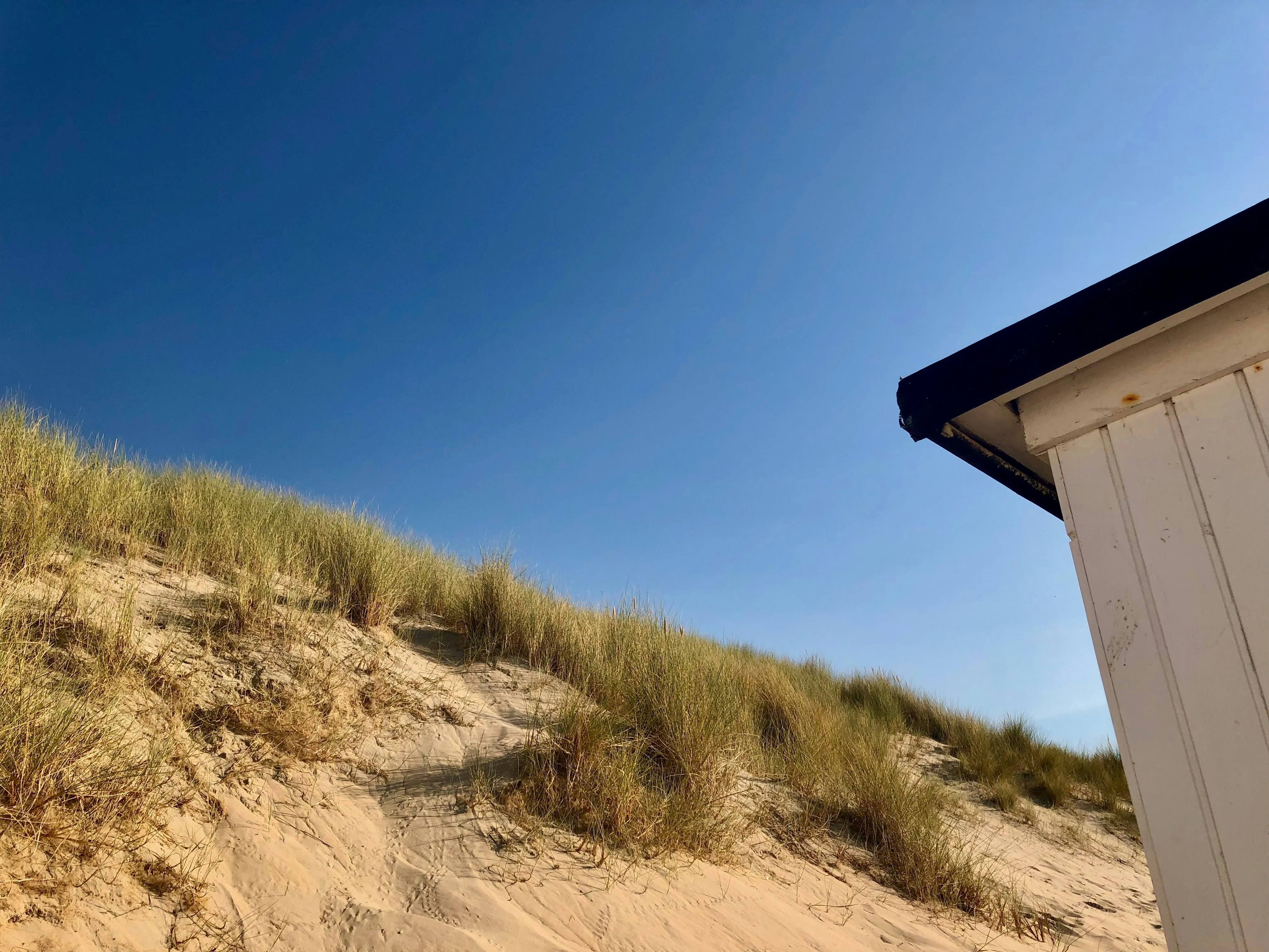 A beach hut sitting on top of a sandy beach