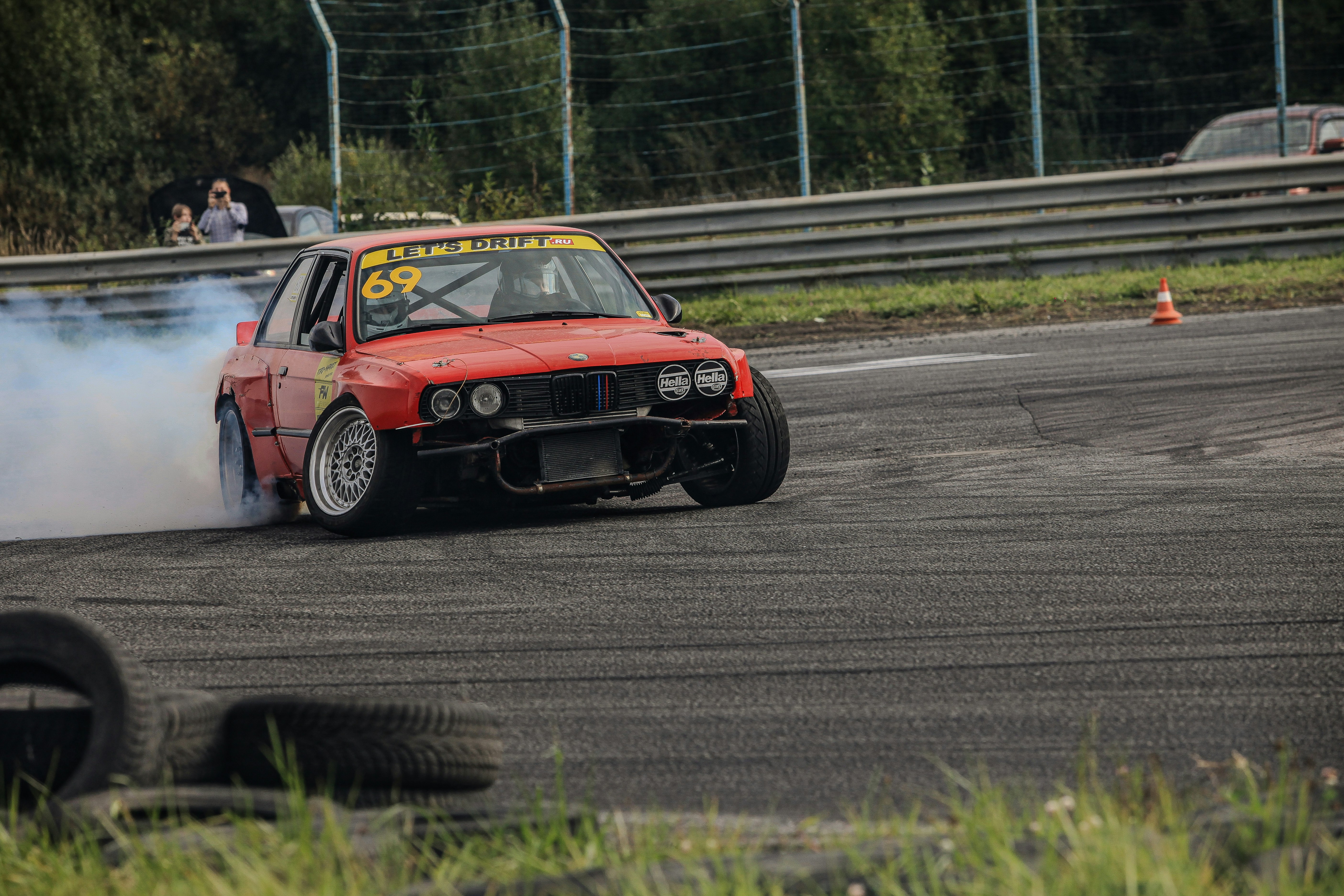 A red car with smoke coming out of it