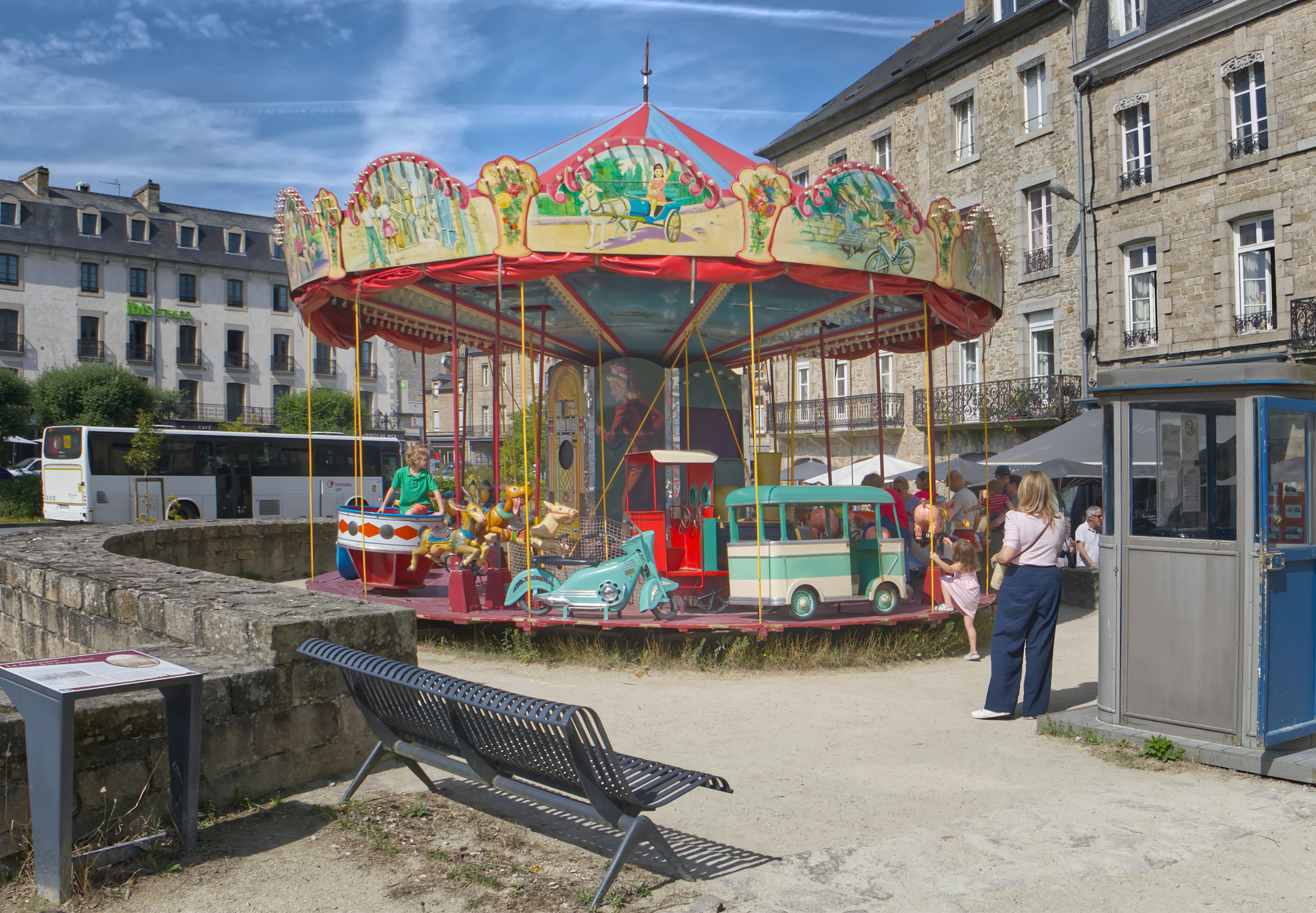 A merry go round with people standing around it