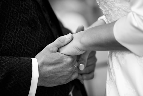 A close up of a person holding a person's hand