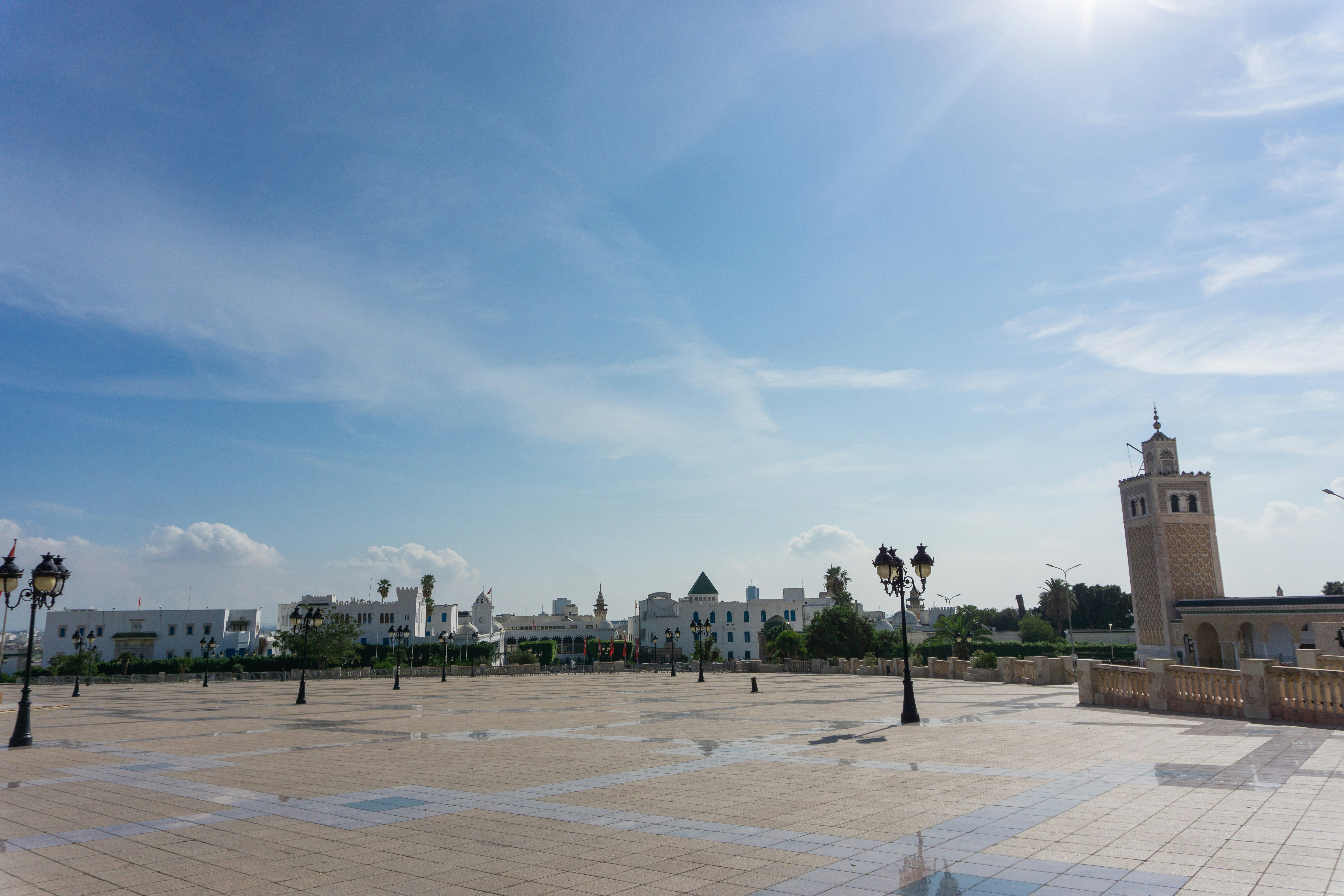 A wide open area with a clock tower in the background