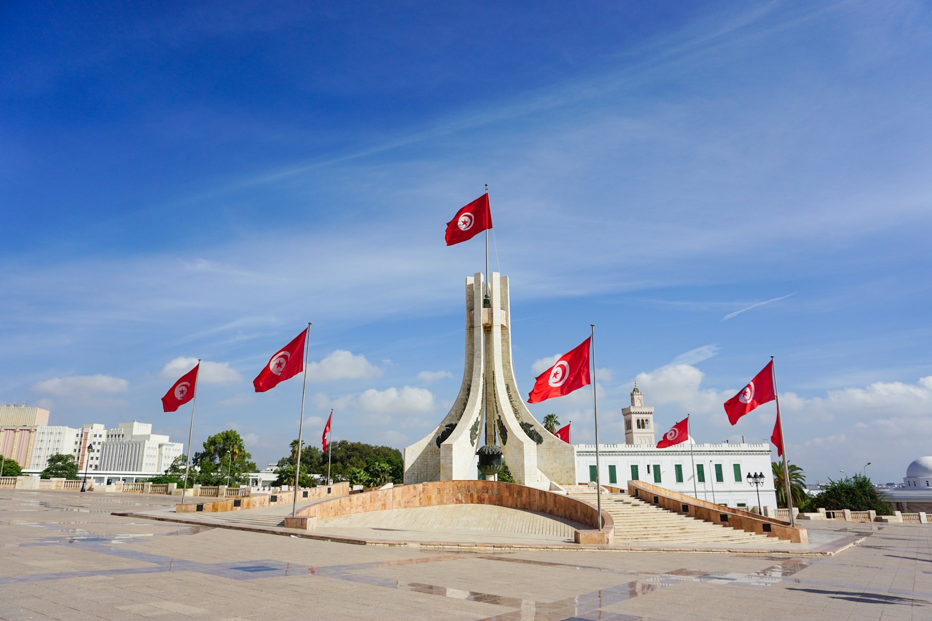 A monument with flags flying in the wind