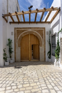 A white building with a large wooden door