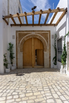 A white building with a large wooden door