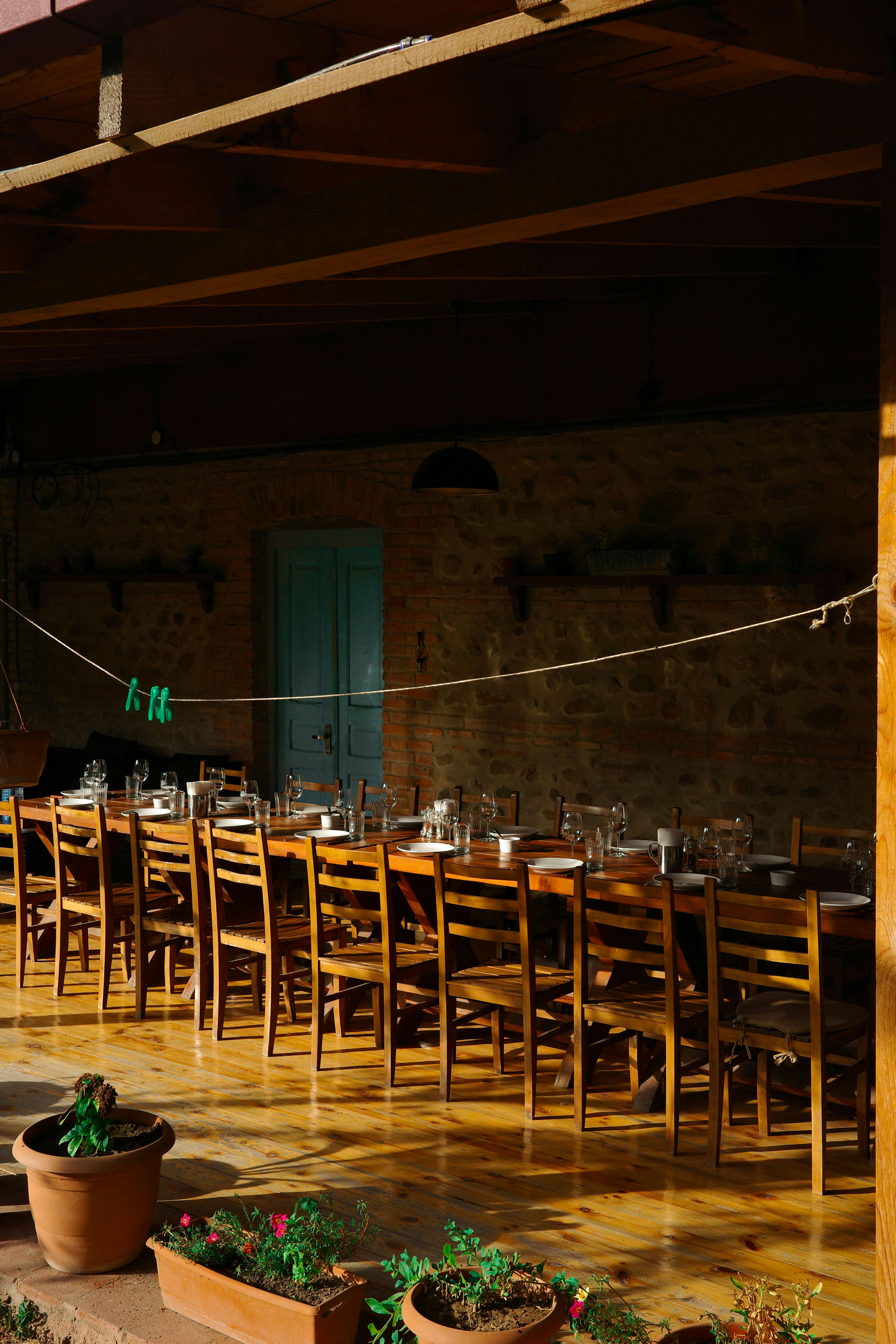 A long wooden table and chairs in a room