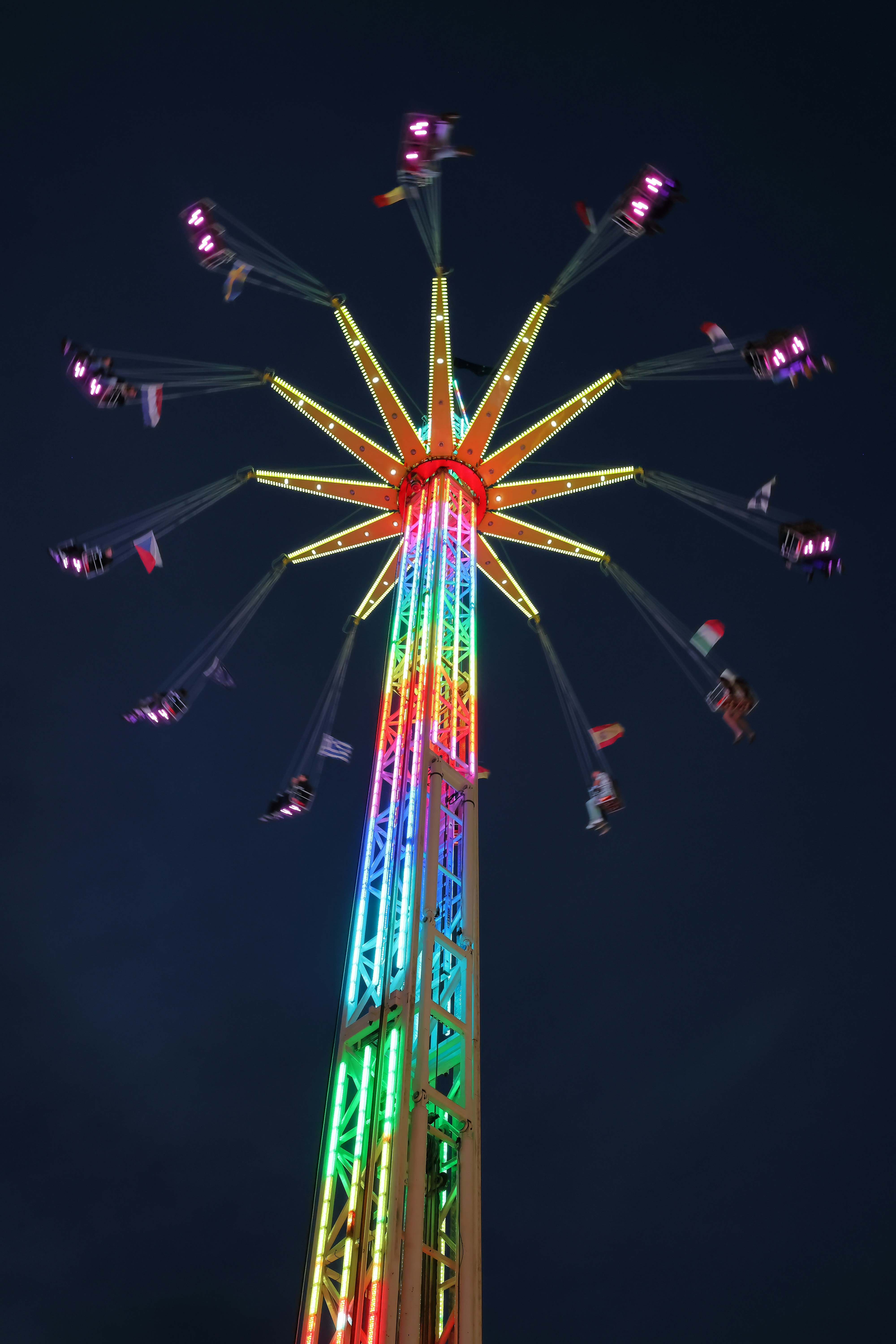 A colorful ferris wheel lit up at night