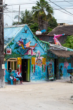 A blue building with a mural on the side of it