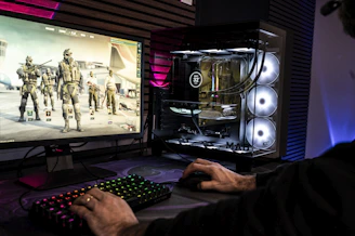 A man is playing a video game on his computer