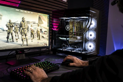 A man is playing a video game on his computer