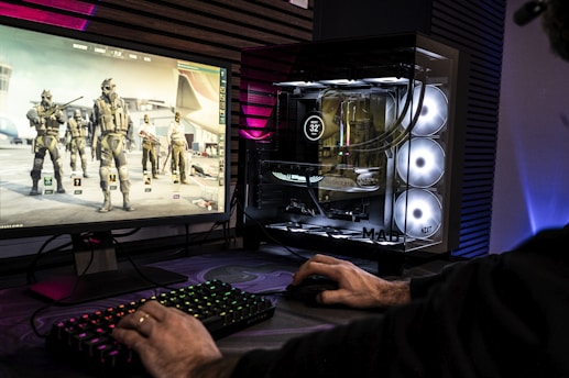 A man is playing a video game on his computer
