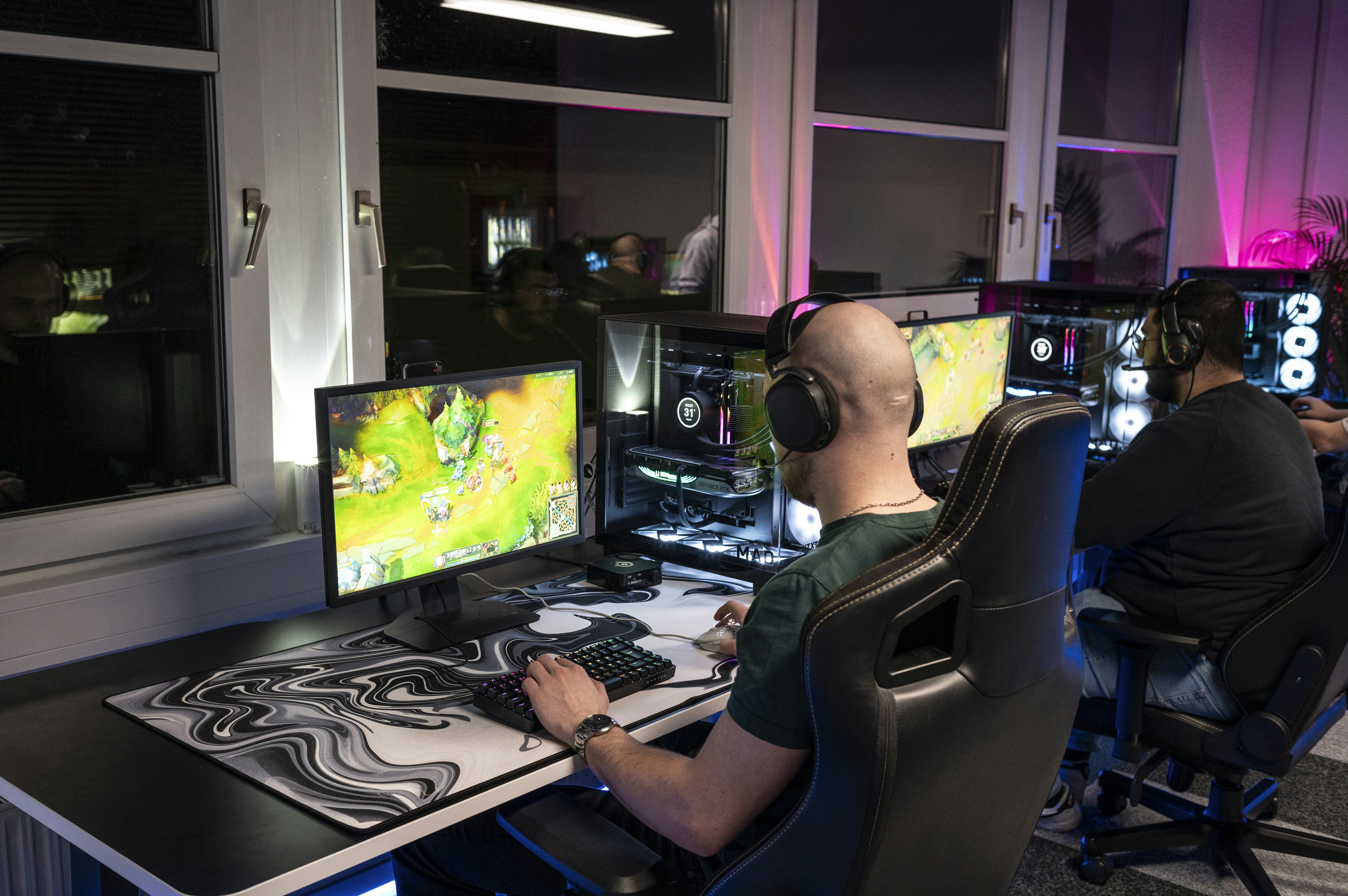 A man sitting in front of a computer monitor